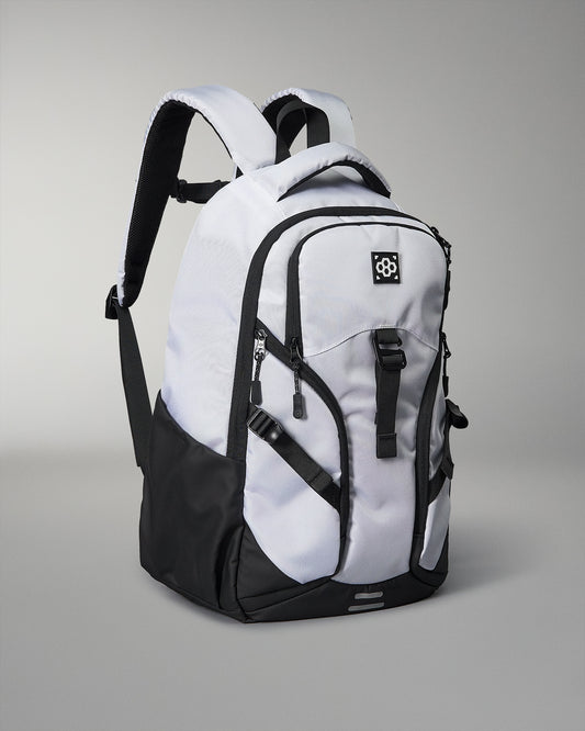 White and black backpack on a gray background