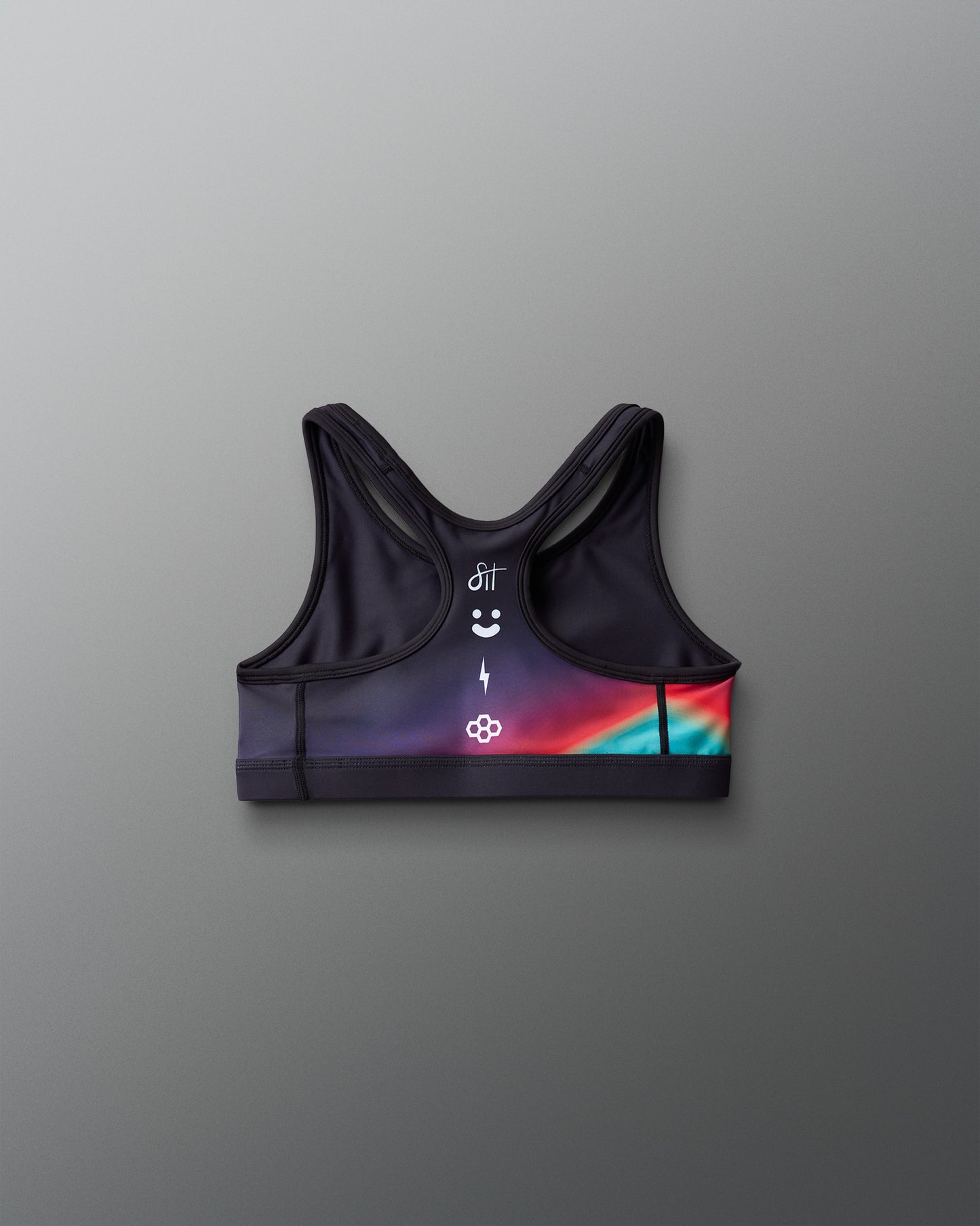 Black sports bra with colorful design on a gray background