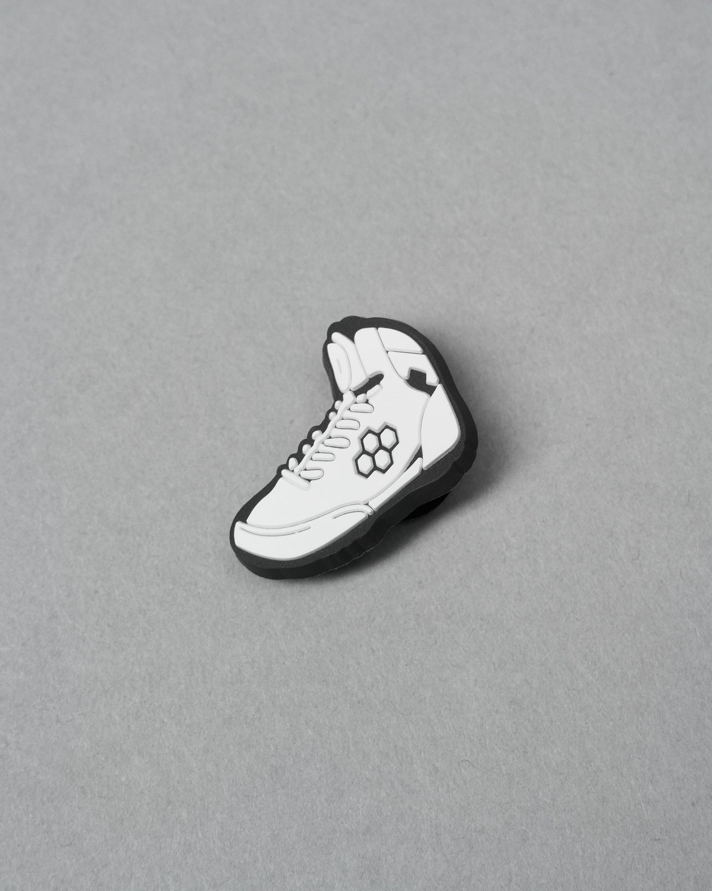 White sneaker with black accents on a gray background