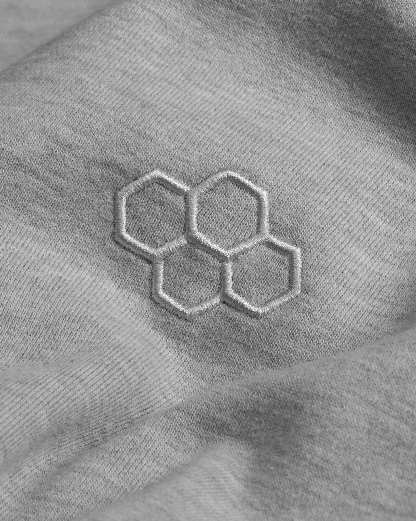 Hexagonal pattern on a textured gray fabric surface