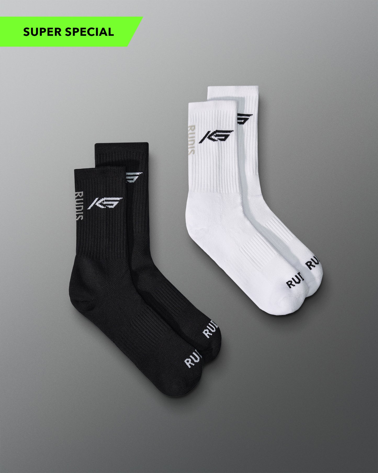 Two pairs of socks, black and white, featuring KS RUDIS logo and RUDIS Word mark on toes of cotton socks.