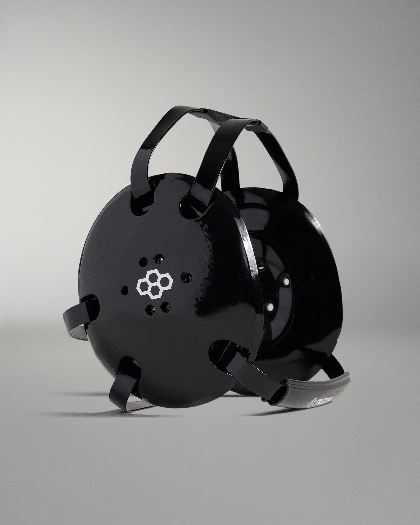 Black wrestling headgear on a gray background