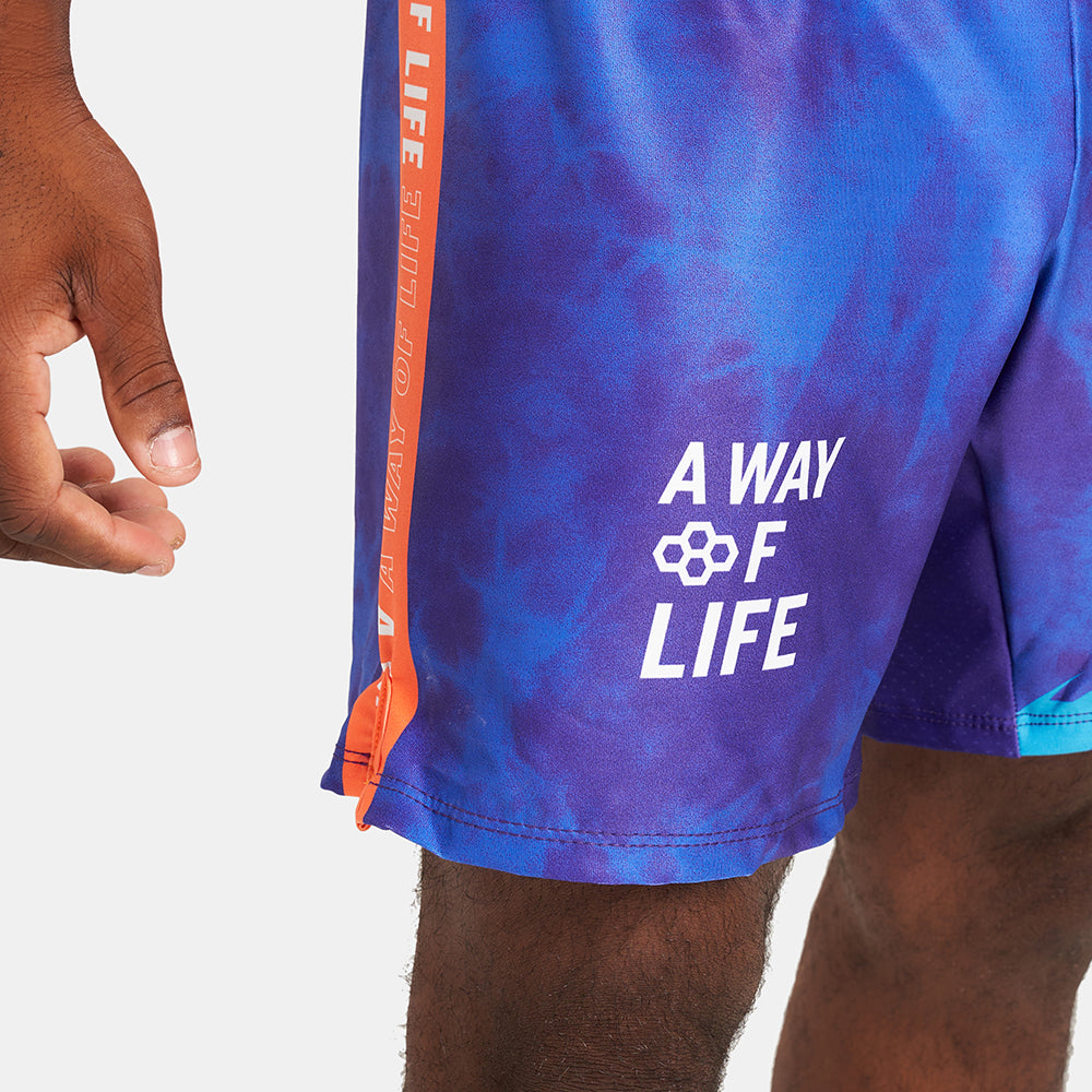 A close-up view of vibrant athletic shorts featuring a purple and blue color gradient and the phrase A WAY OF LIFE printed in white