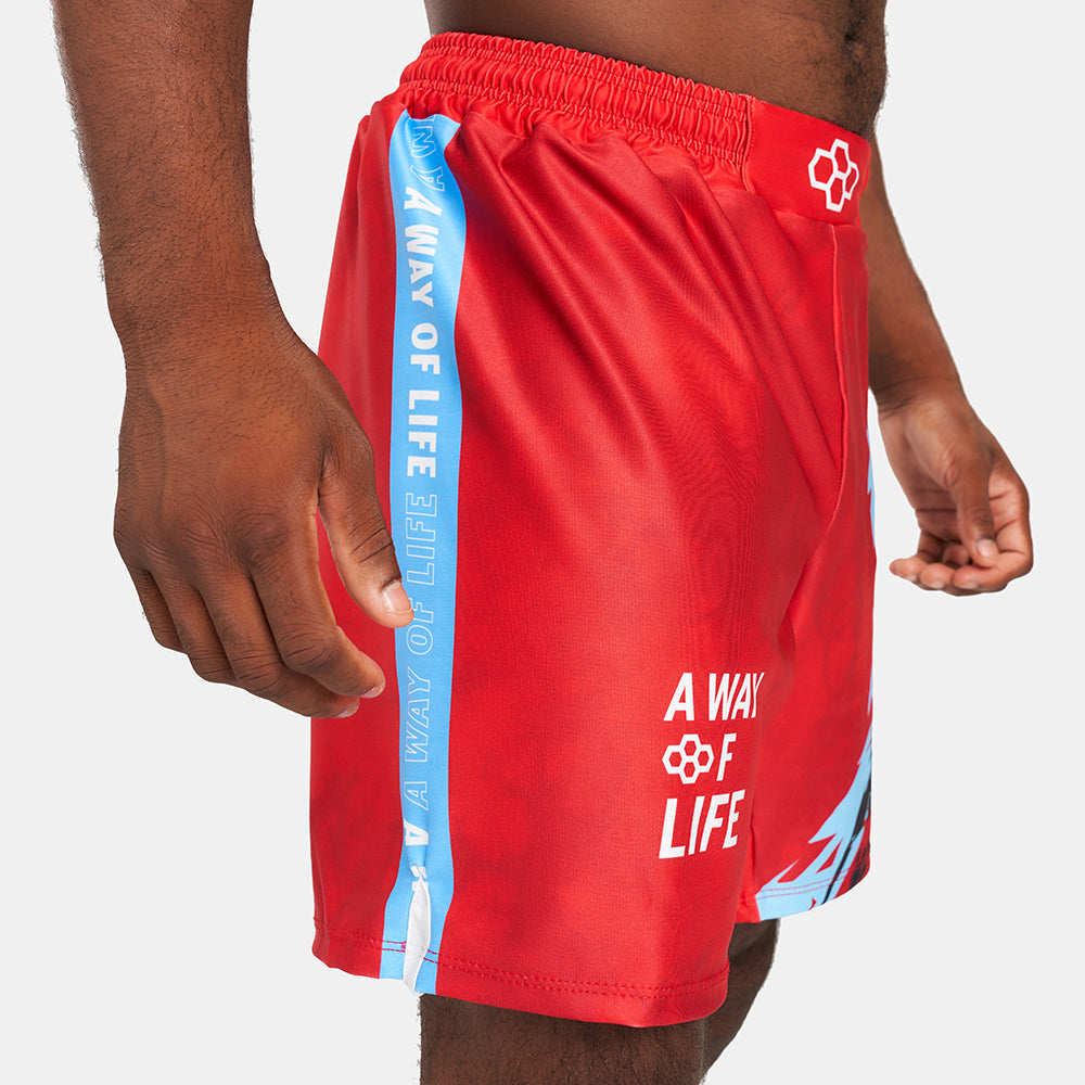 A close-up view of a person wearing vibrant red swimming shorts featuring bold text and design elements ideal for swimwear fashion