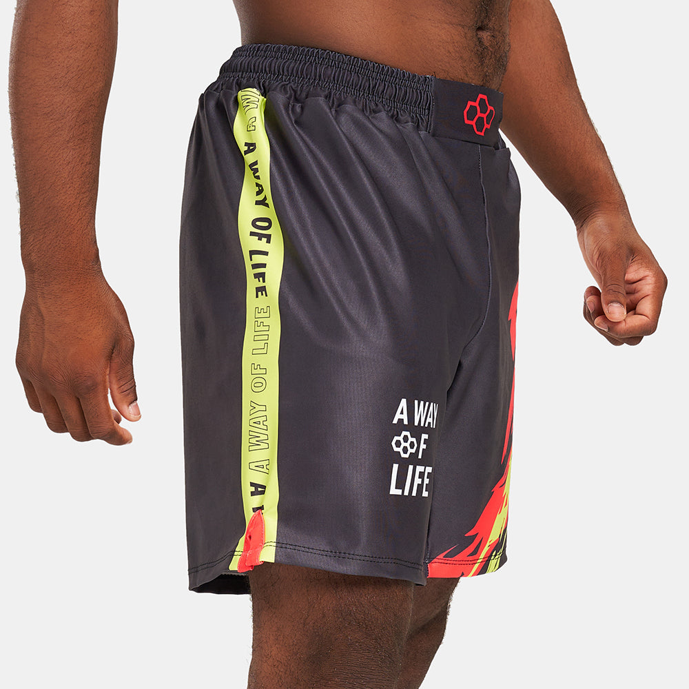A person wearing stylish black swim shorts featuring vibrant graphics and bold text suitable for active lifestyles and beachwear