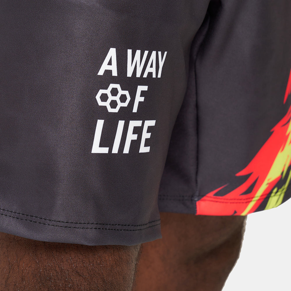 A close-up view of athletic shorts featuring the phrase A WAY OF LIFE and a vibrant flame design