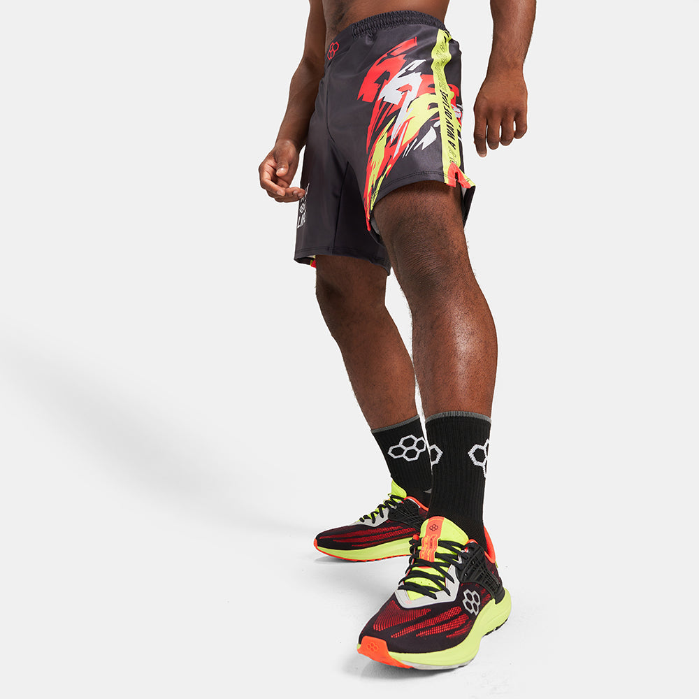 A sporty outfit featuring vibrant running shoes patterned shorts and black athletic socks showcasing a dynamic athletic look