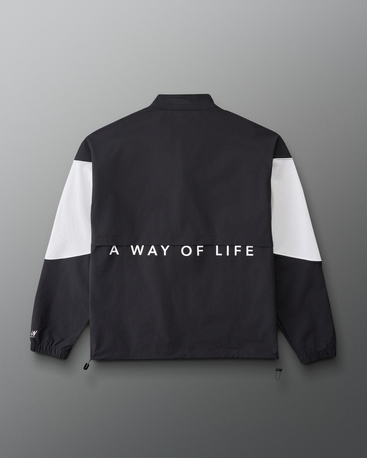 Back view of the RUDIS Full Zip Movement Podium Jacket in black and white featuring “A WAY OF LIFE” across the back.
