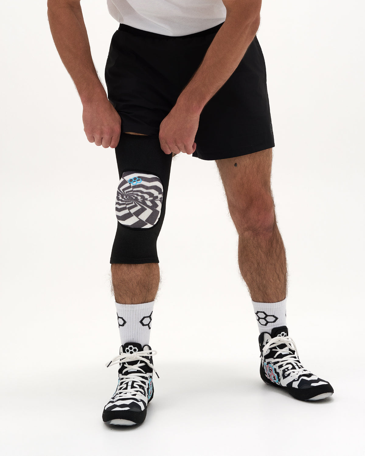 Close-up of RUDIS HPS Cushion Hypnosis Wrestling Knee Pad showing the black sleeve and Hypnosis graphic cushion