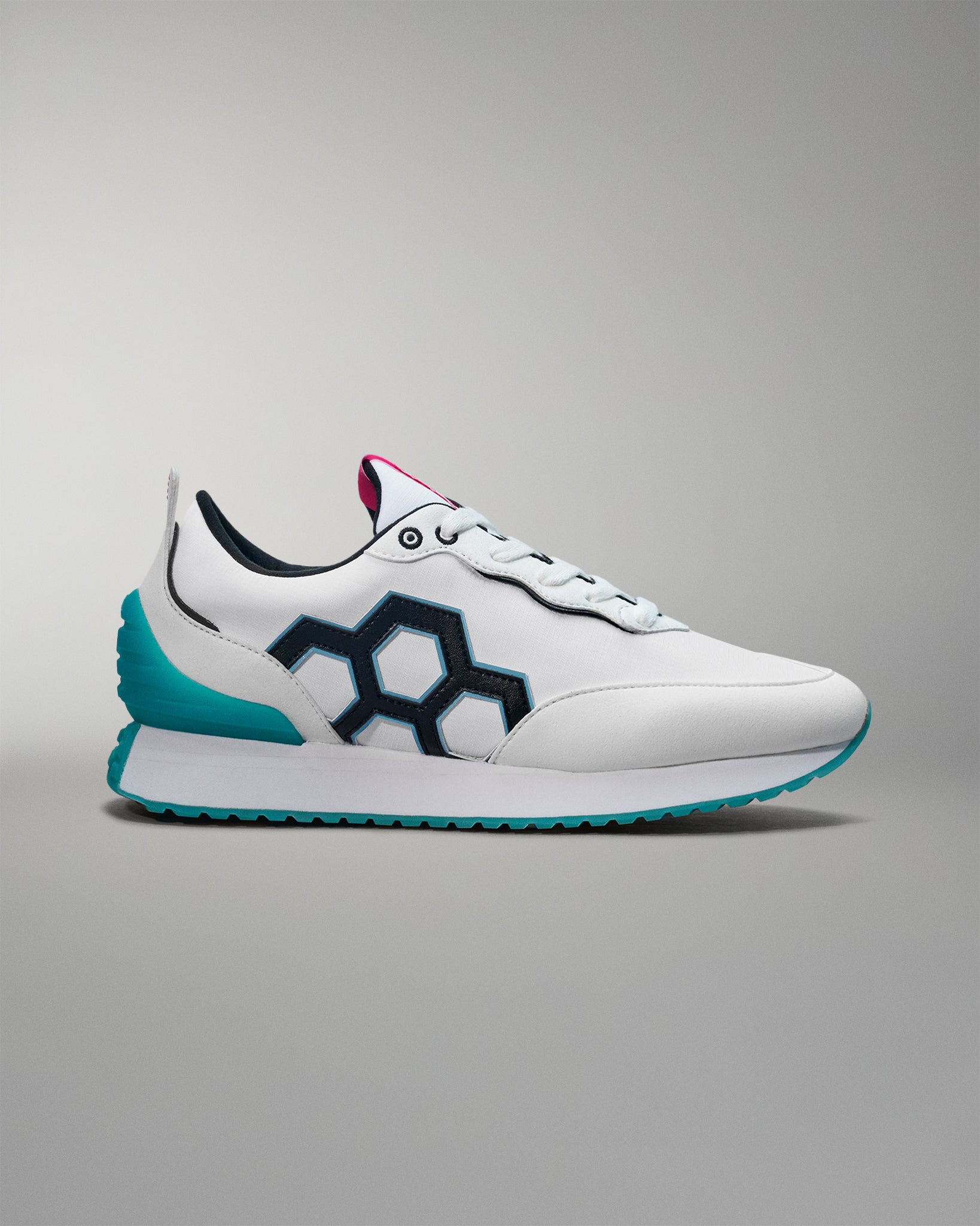 White sneaker with blue sole on a gray background