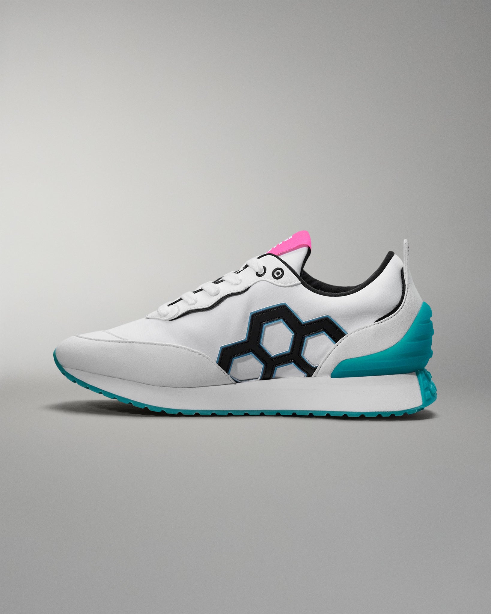 White sneaker with blue sole and pink accent on a gray background