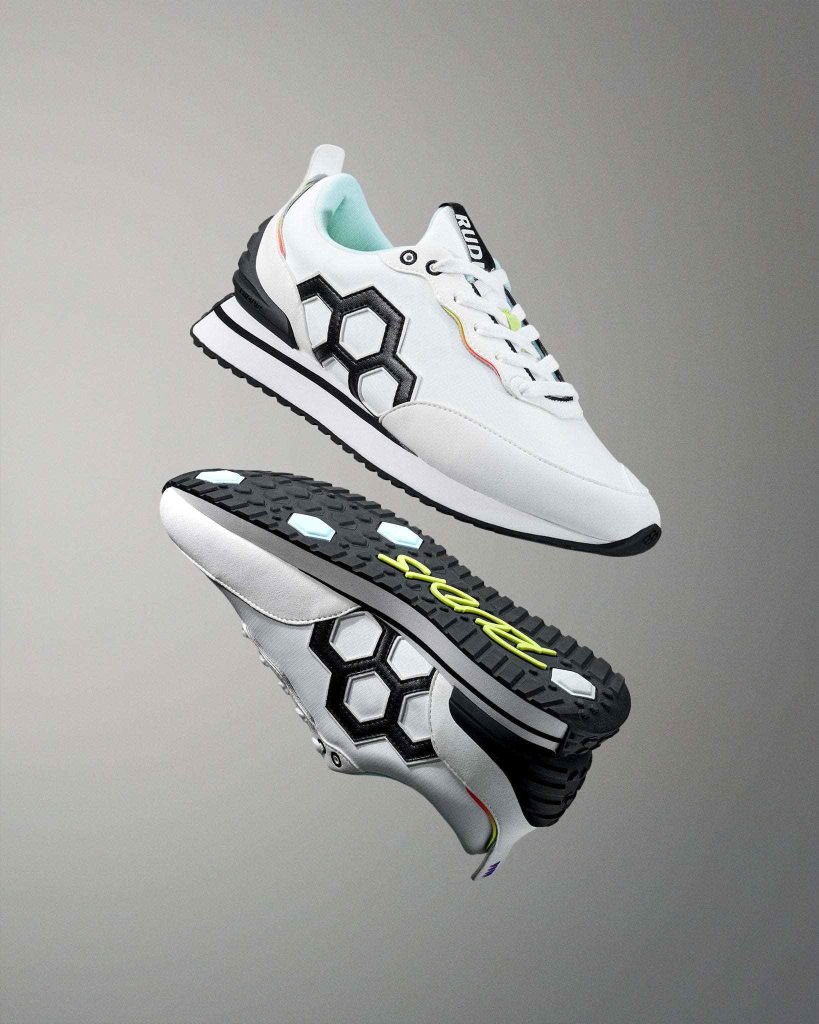 White sneakers with black and colorful accents on a gray background