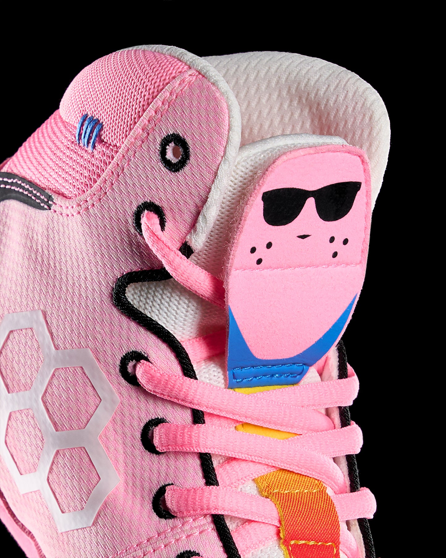 Close-up of a pink wrestling shoe with sunglasses energizer bunny design on a black background
