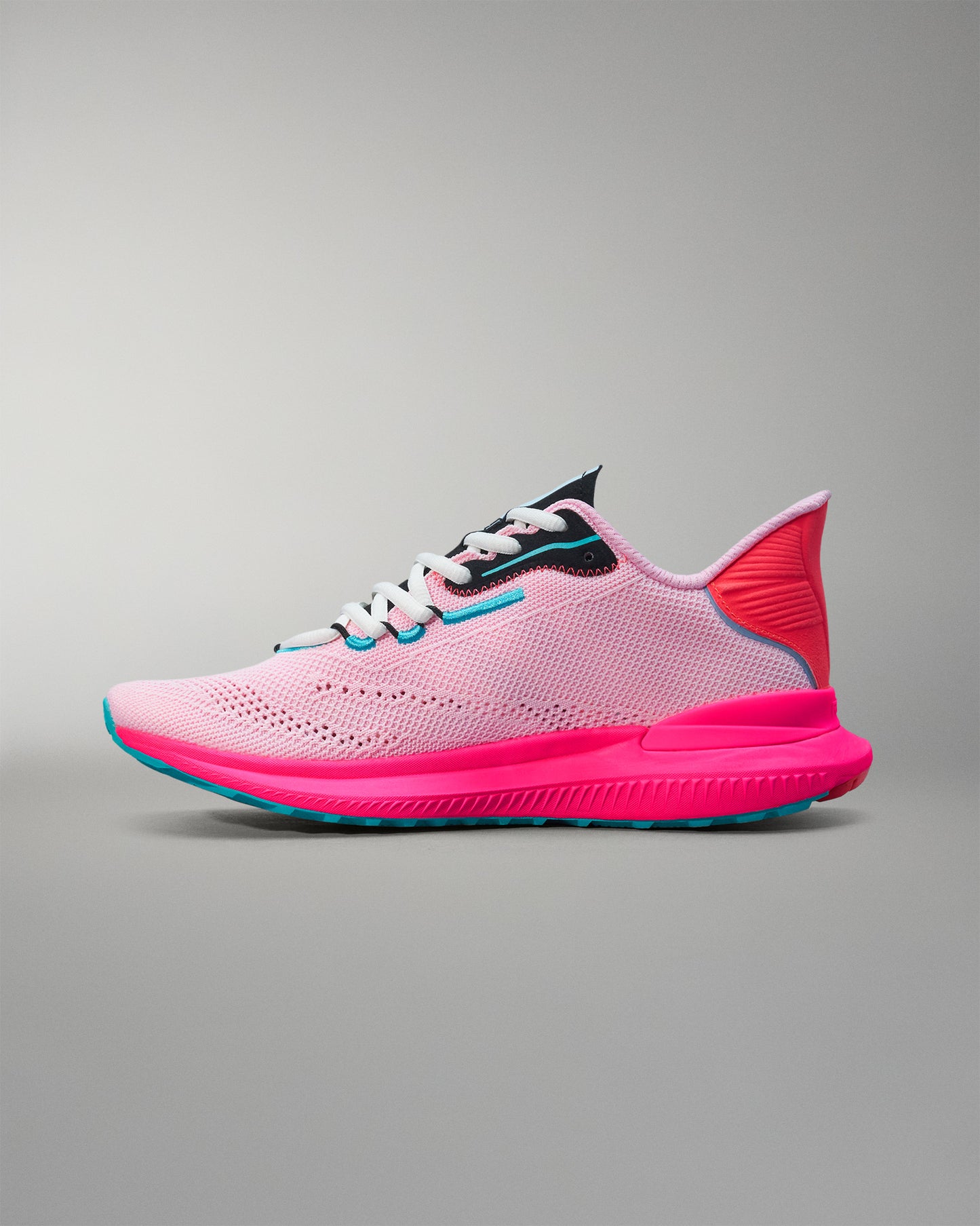 Pink and blue running shoe on a gray background
