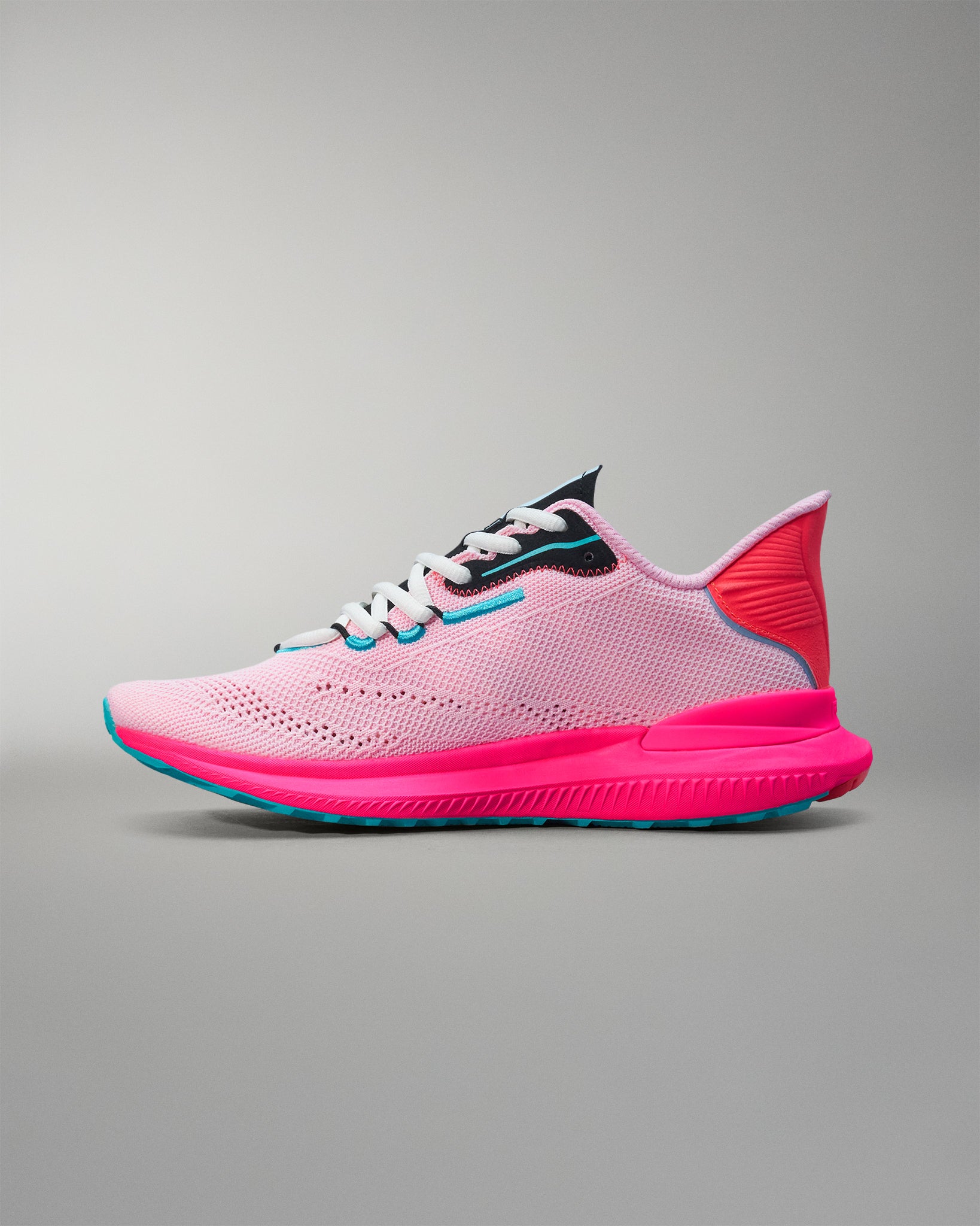 Pink and blue running shoe on a gray background