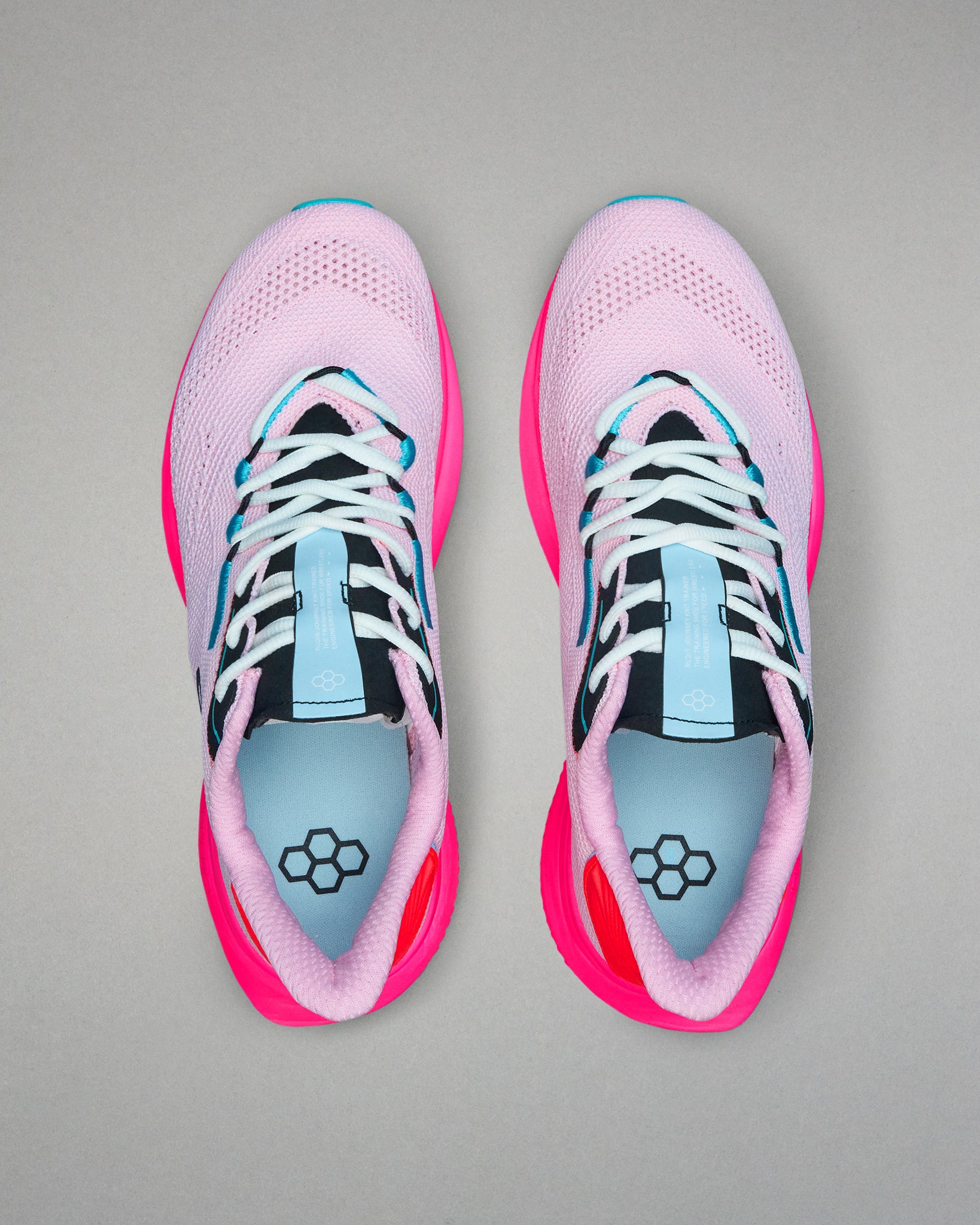 Pair of pink and black running shoes with blue accents on a gray background