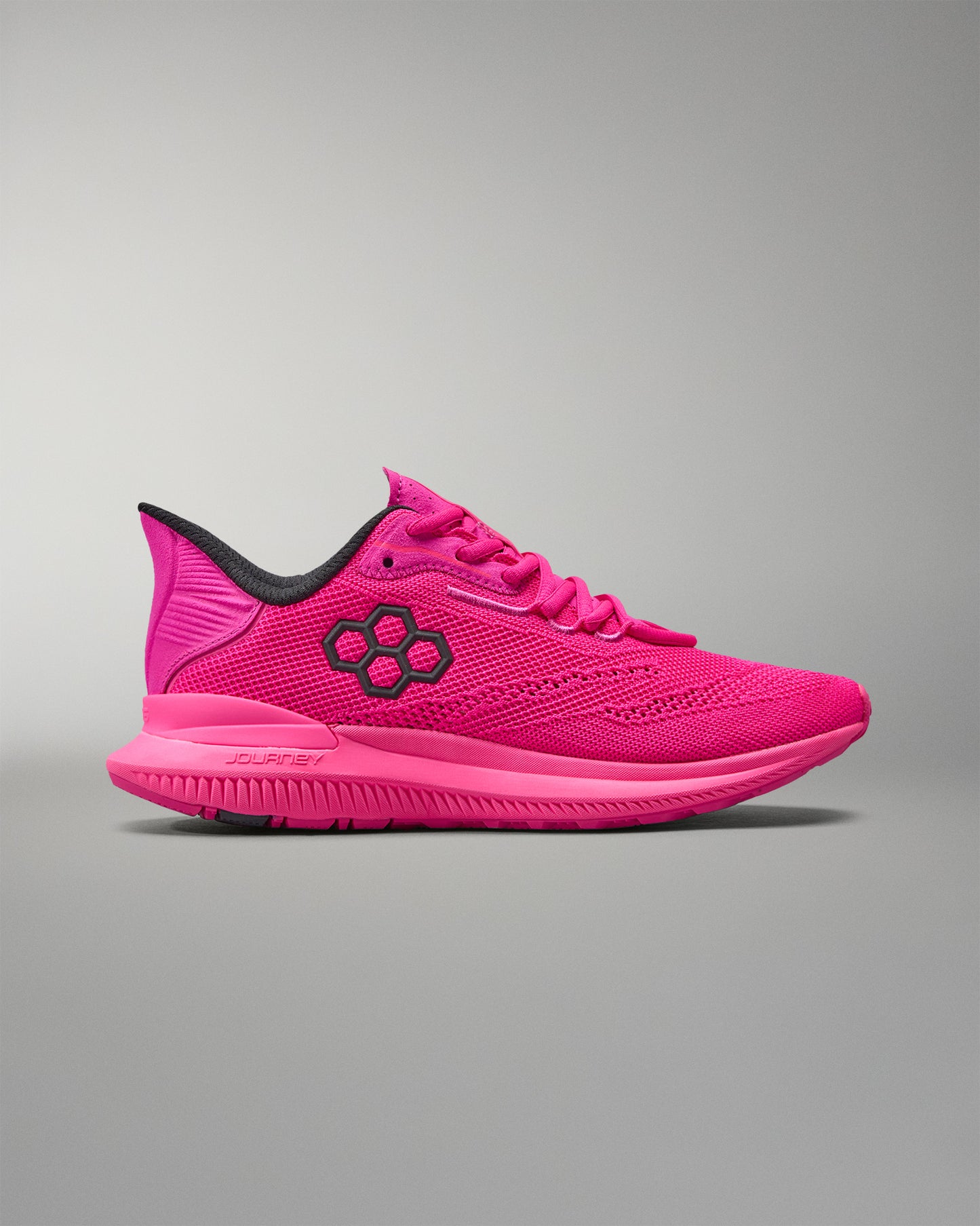 Pink running shoe with black accents on a gray background