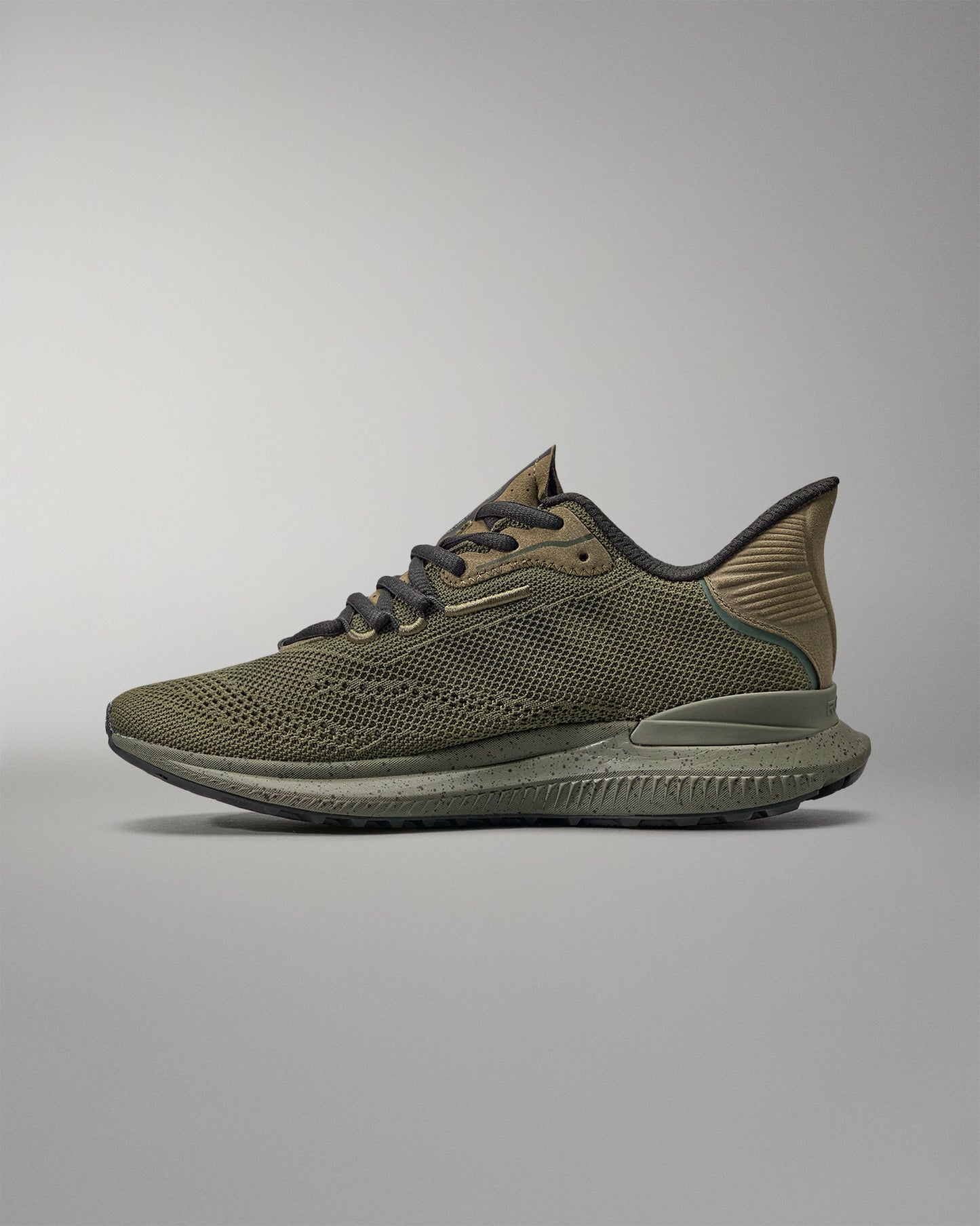 Green training shoe on a gray background