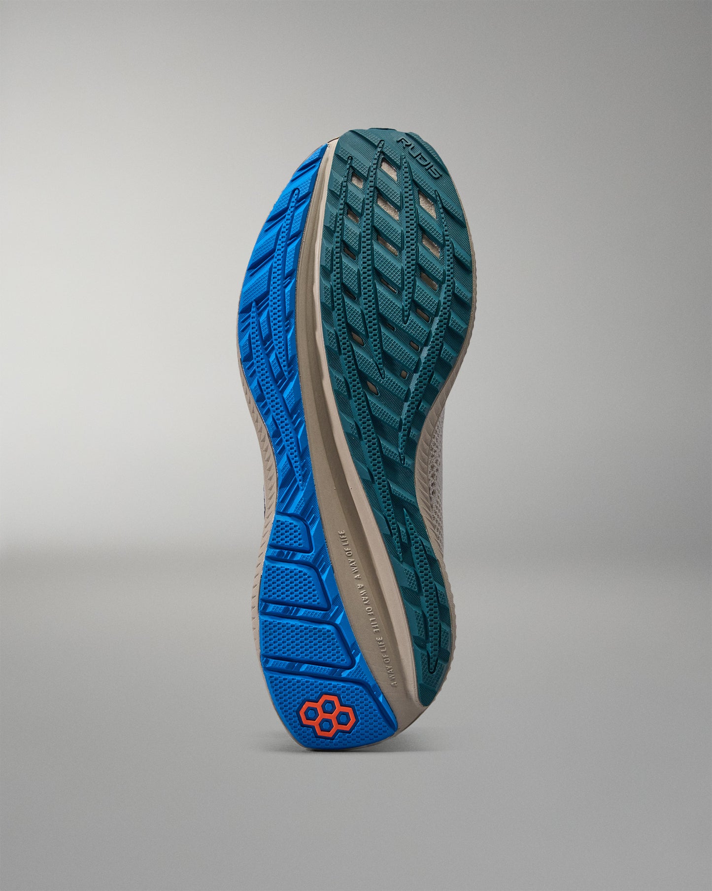 Close-up of a shoe sole with blue tread pattern on a gray background