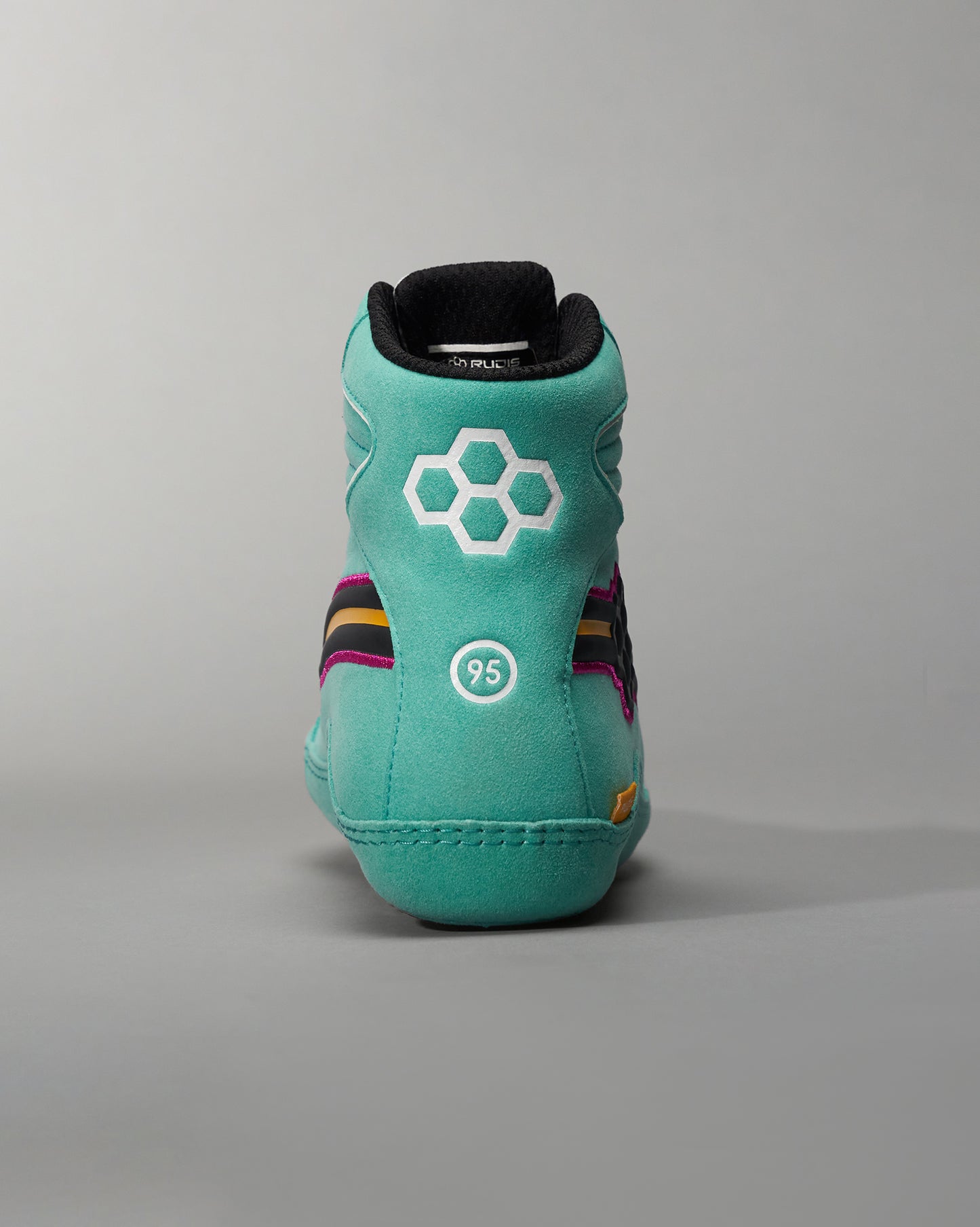 A stylish turquoise athletic shoe with unique design elements including purple and black accents showcasing a modern silhouette suitable for both sports and casual wear