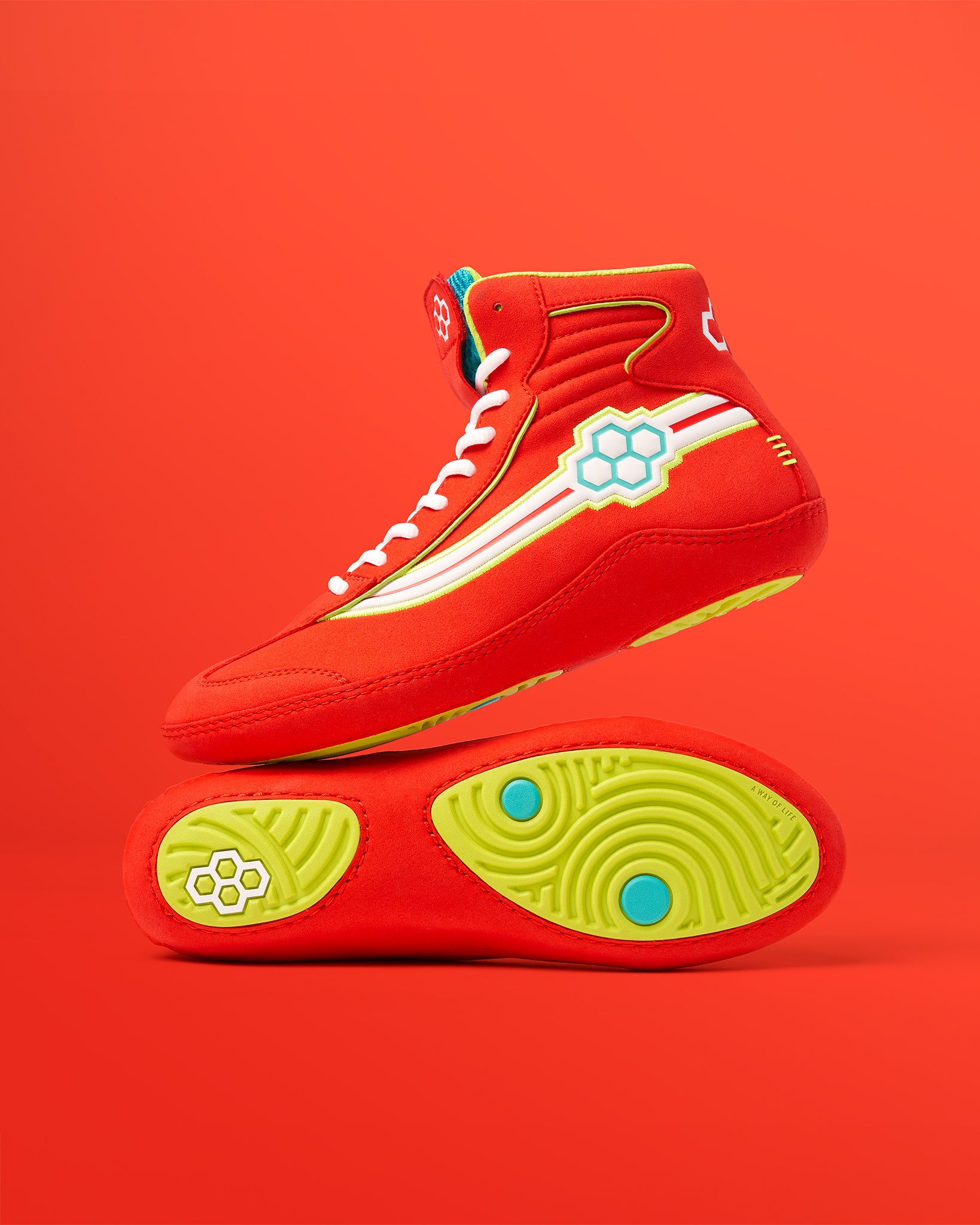 A vibrant pair of red high-top sneakers with unique design elements and a bold sole set against a matching background