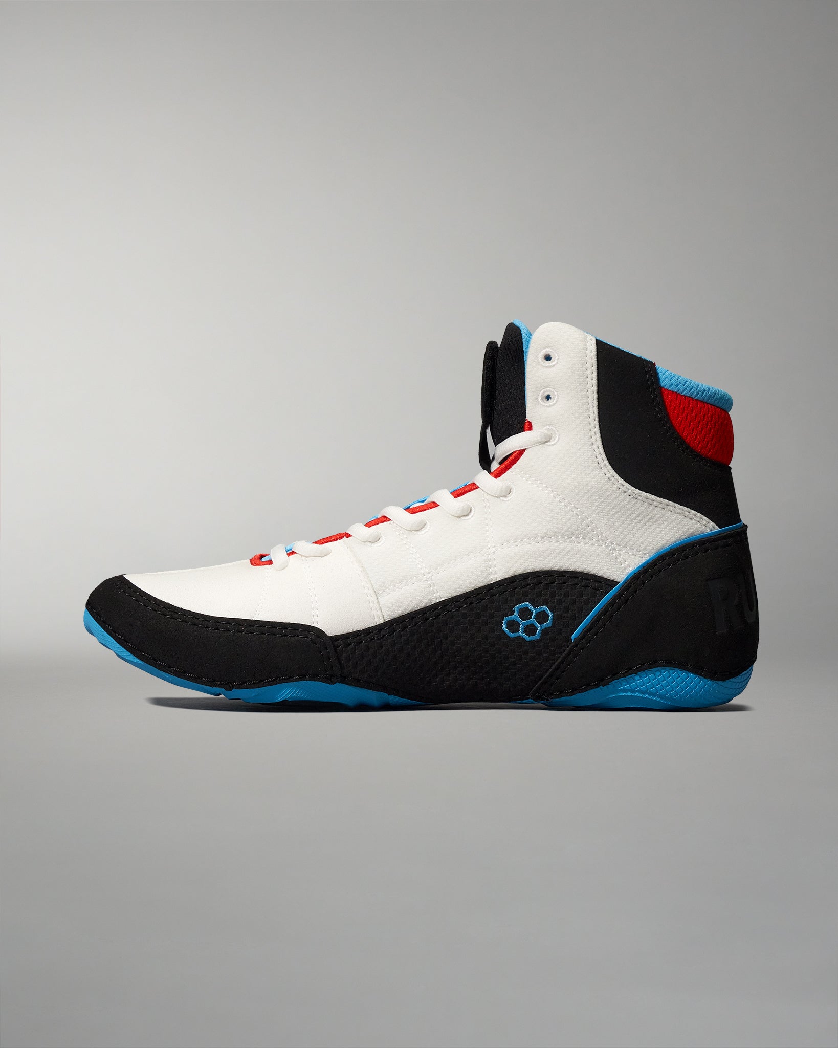 High-top athletic shoe showcasing a white upper with black and blue accents, designed for performance and grip, against a soft gray background.