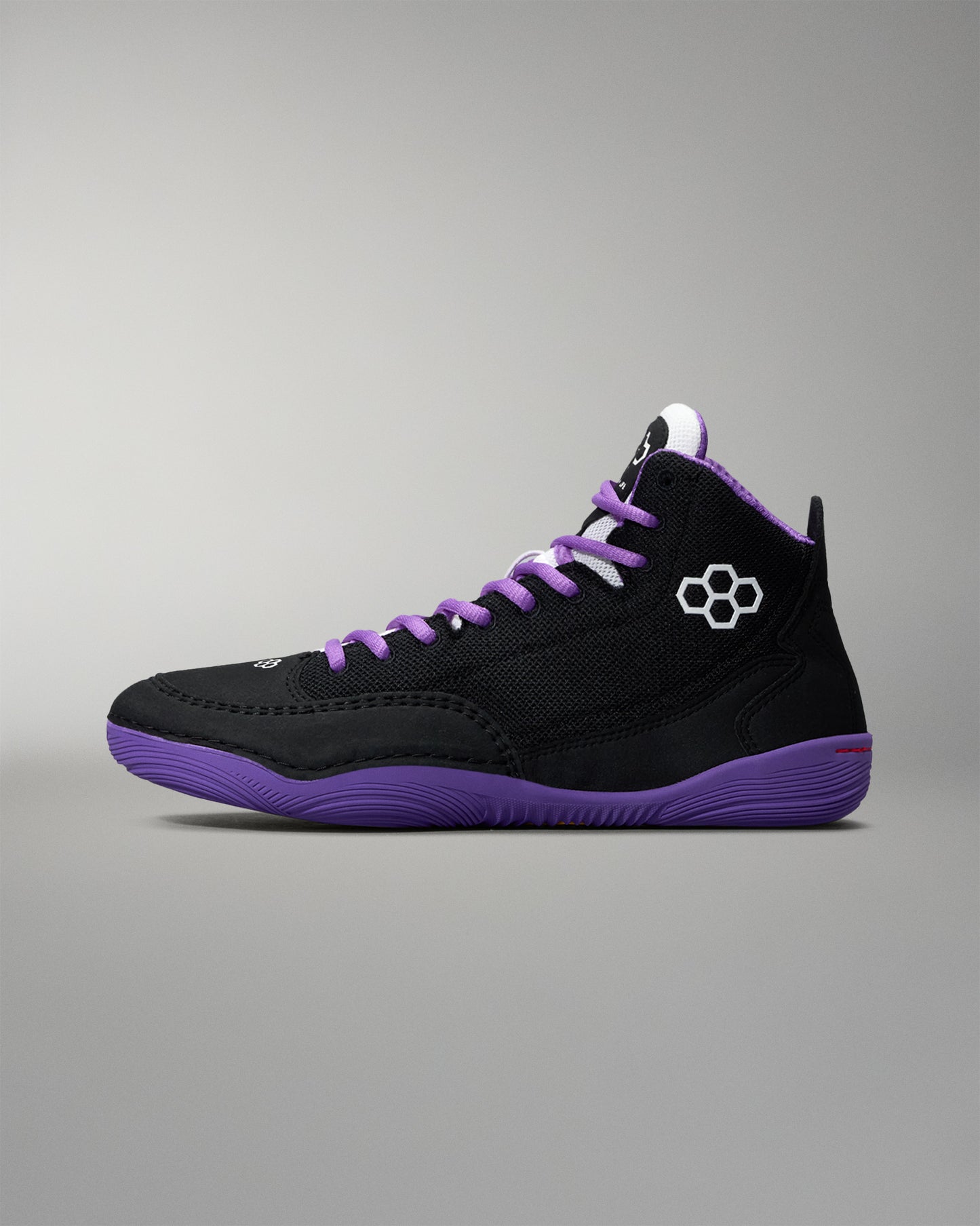 Black and purple sneaker with a gray background