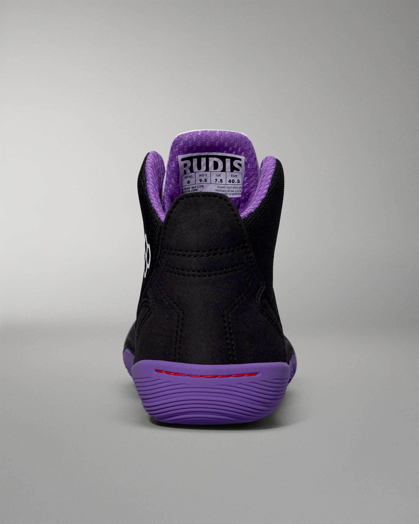 Black high-top sneaker with purple accents on a gray background