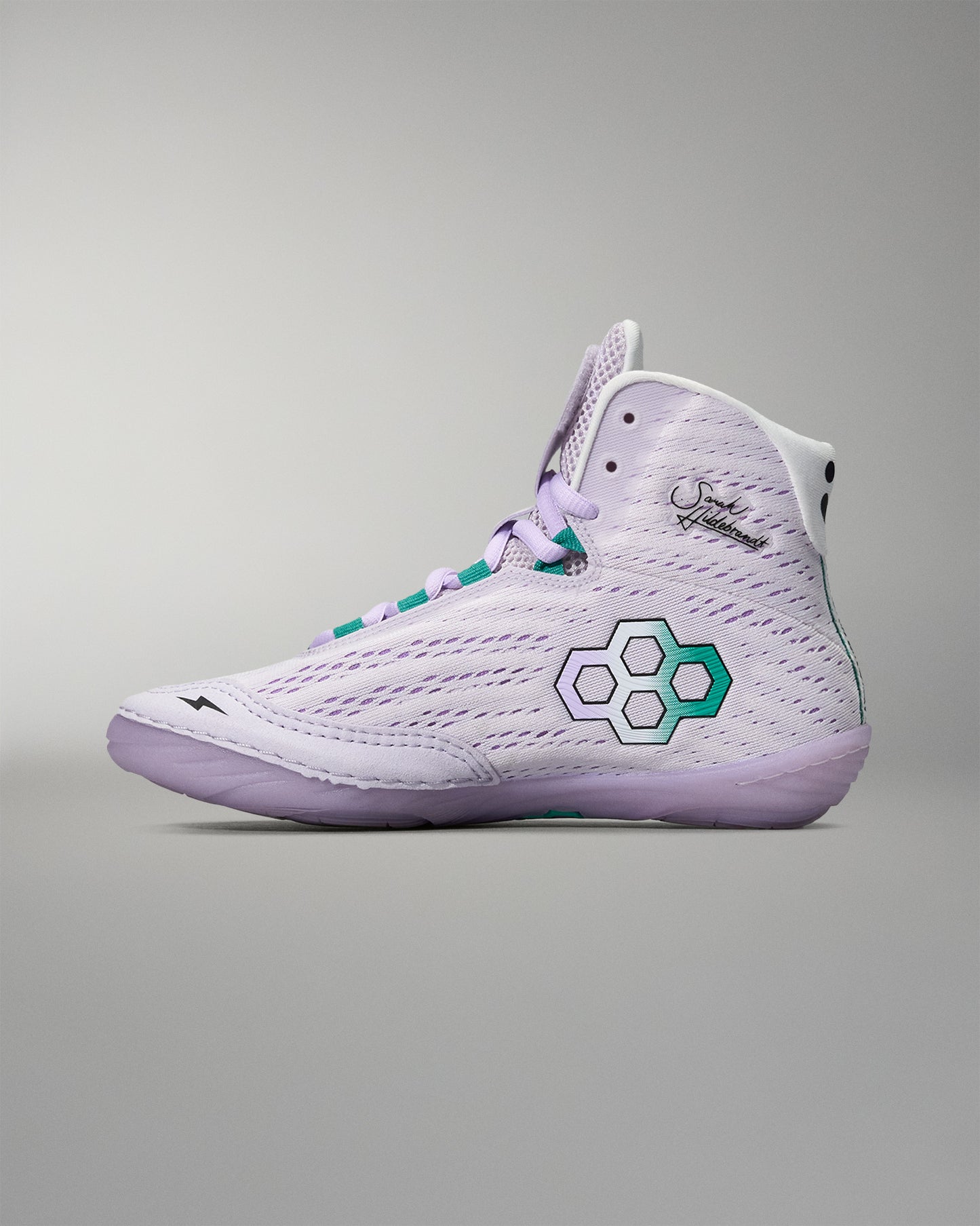 White high-top sneaker with a green logo on a gray background