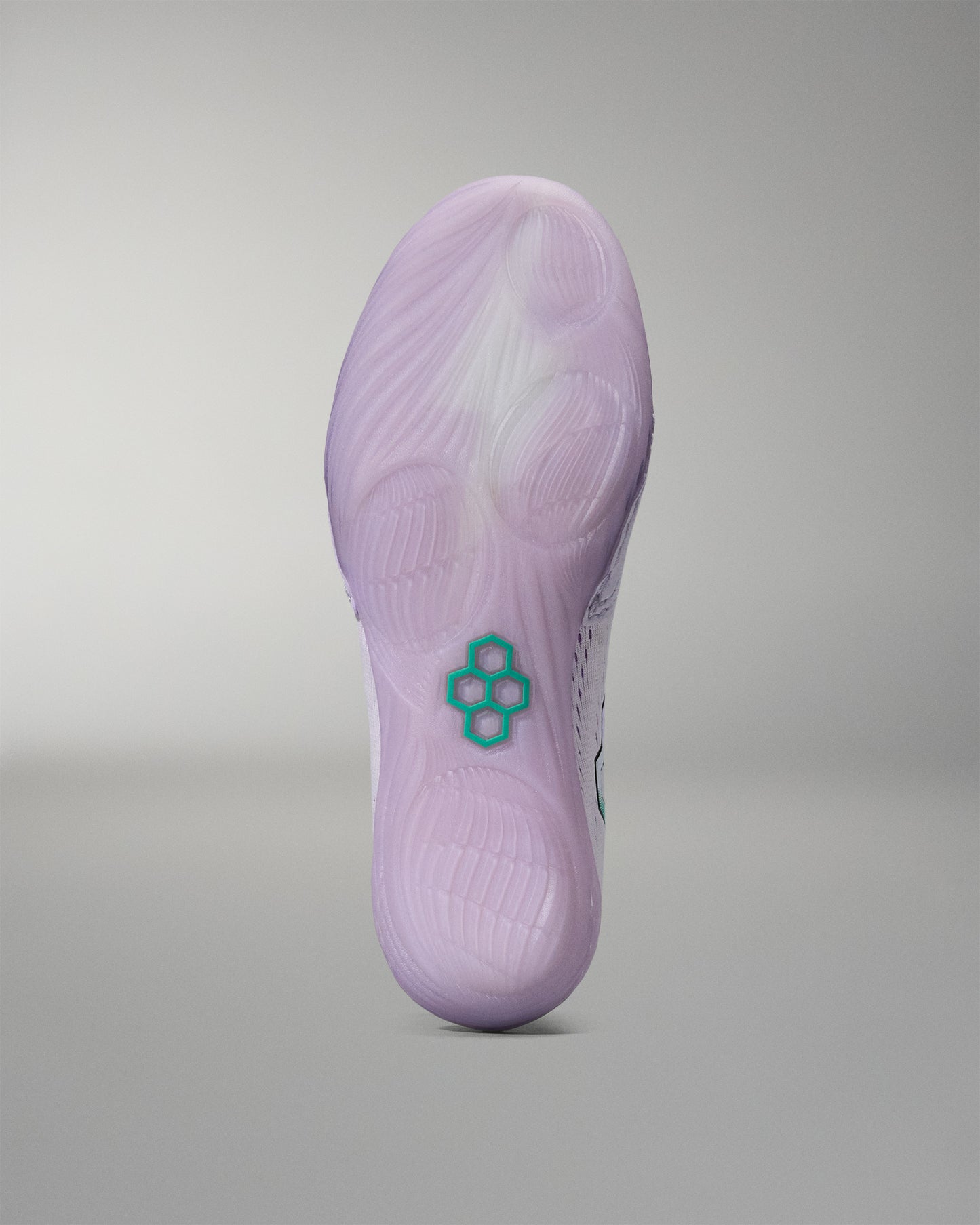 Purple shoe sole with a green RUDIS logo on a gray background