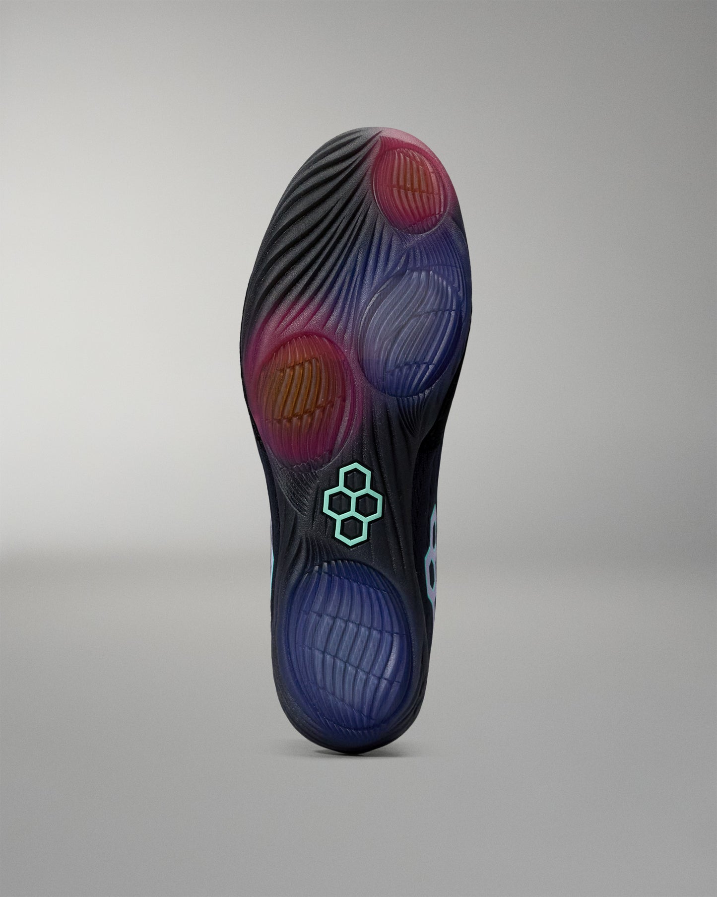 Close-up of a shoe sole with a brand logo on a gray background