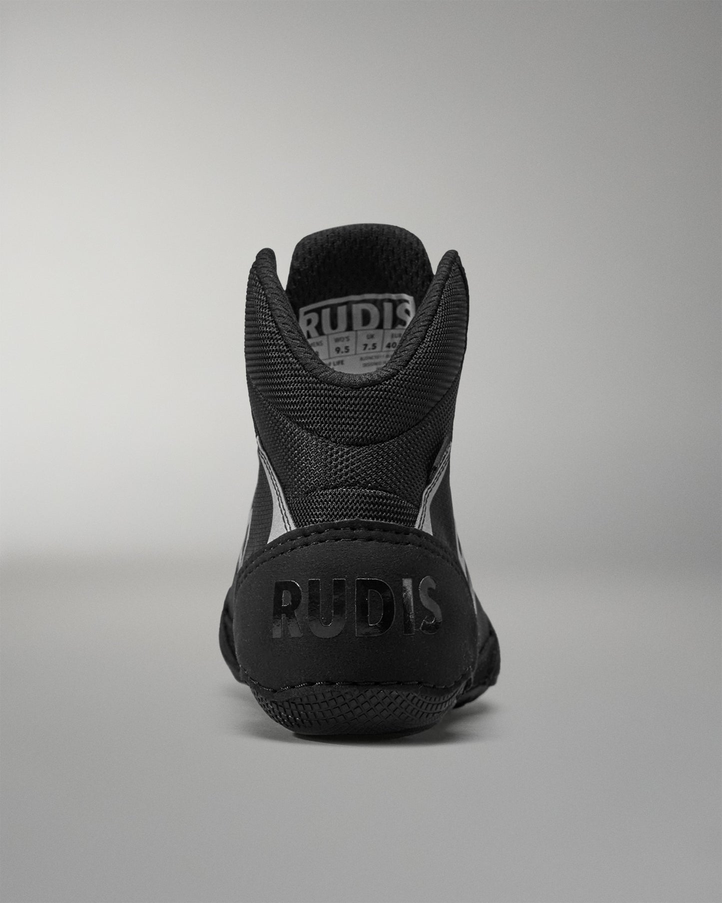 Black Wrestling shoe with 'RUDIS' branding on a gray background