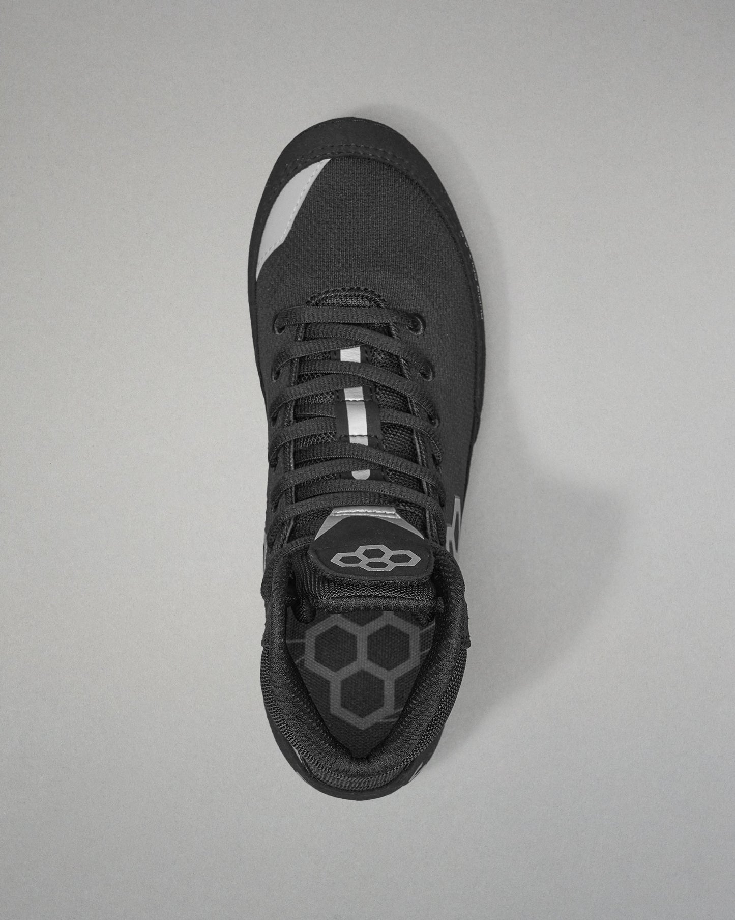 Black Wrestling shoe with a unique sole design on a gray background
