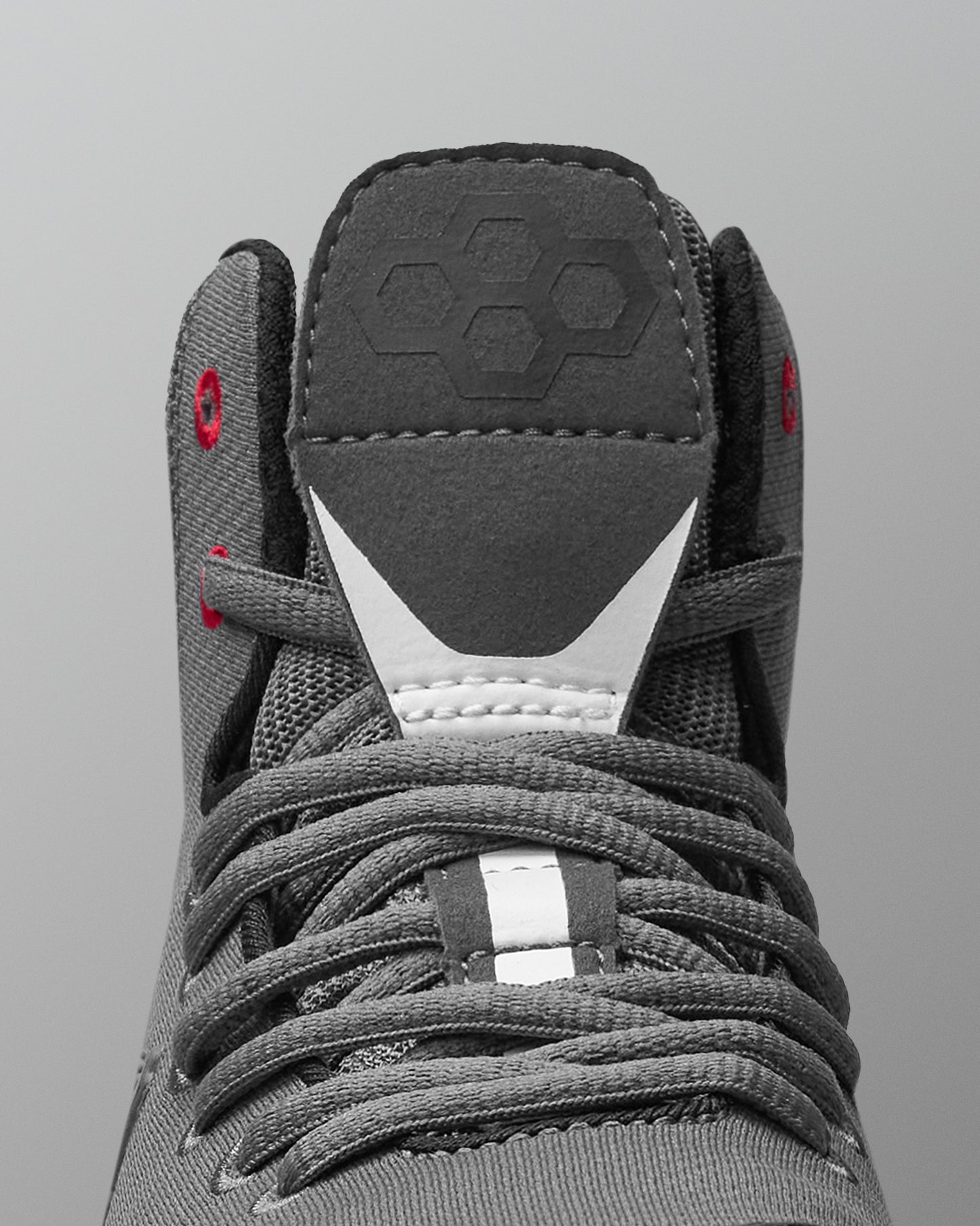 Gray wrestling shoe with laces on a gray background