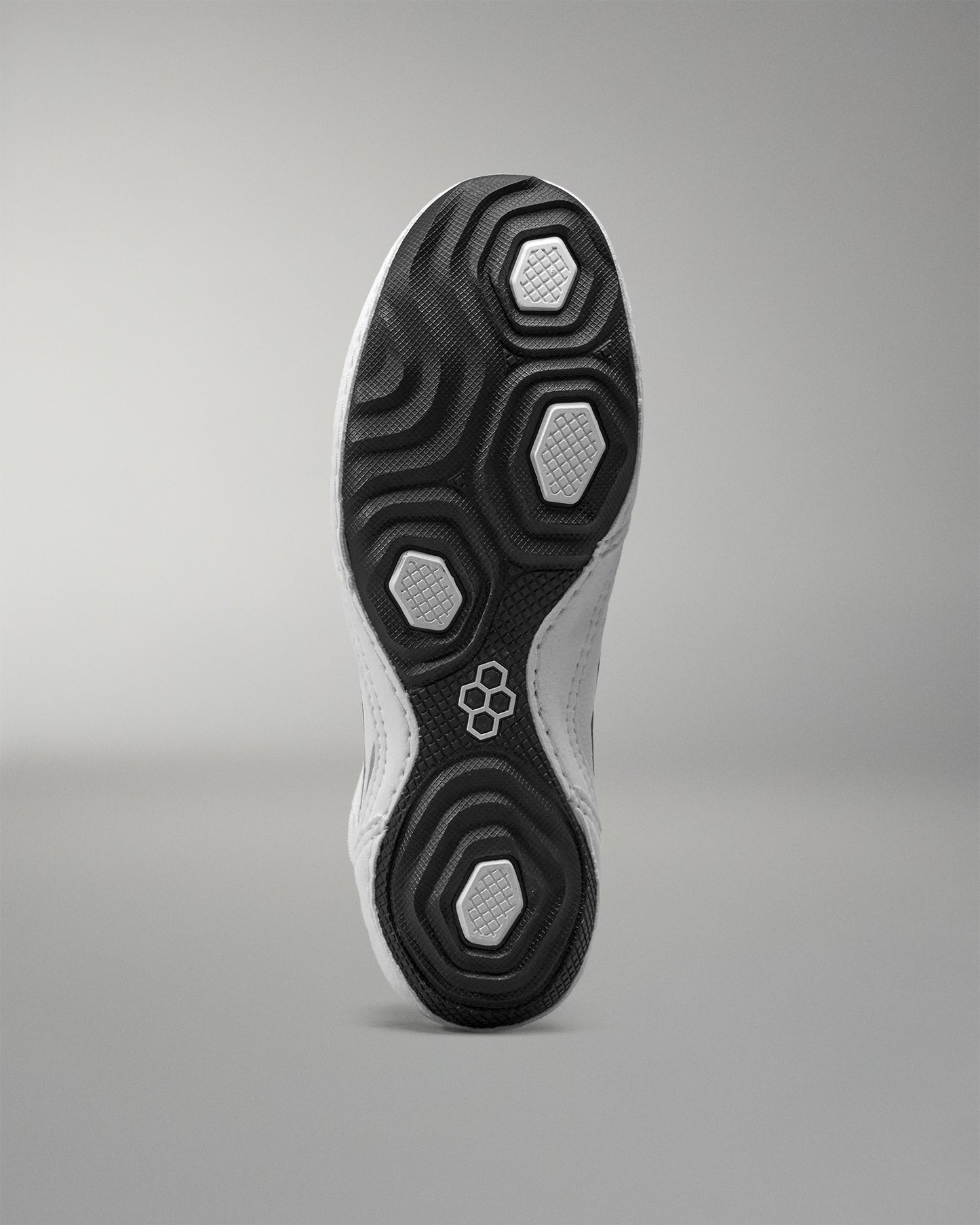 Close-up of a Wrestling shoe sole with a geometric pattern on a gray background