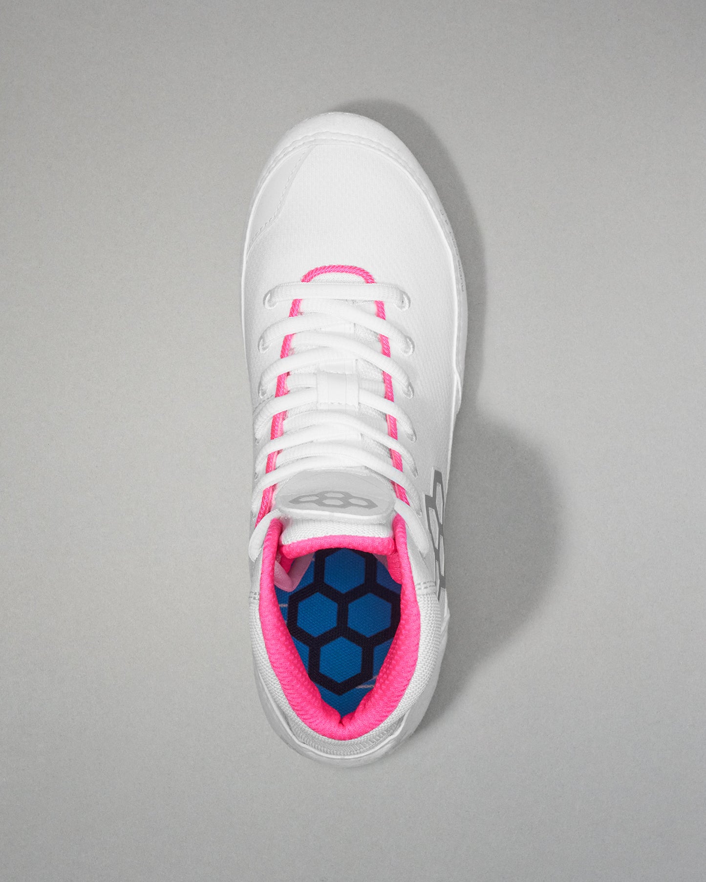 White wrestling shoe with pink accents on a gray background