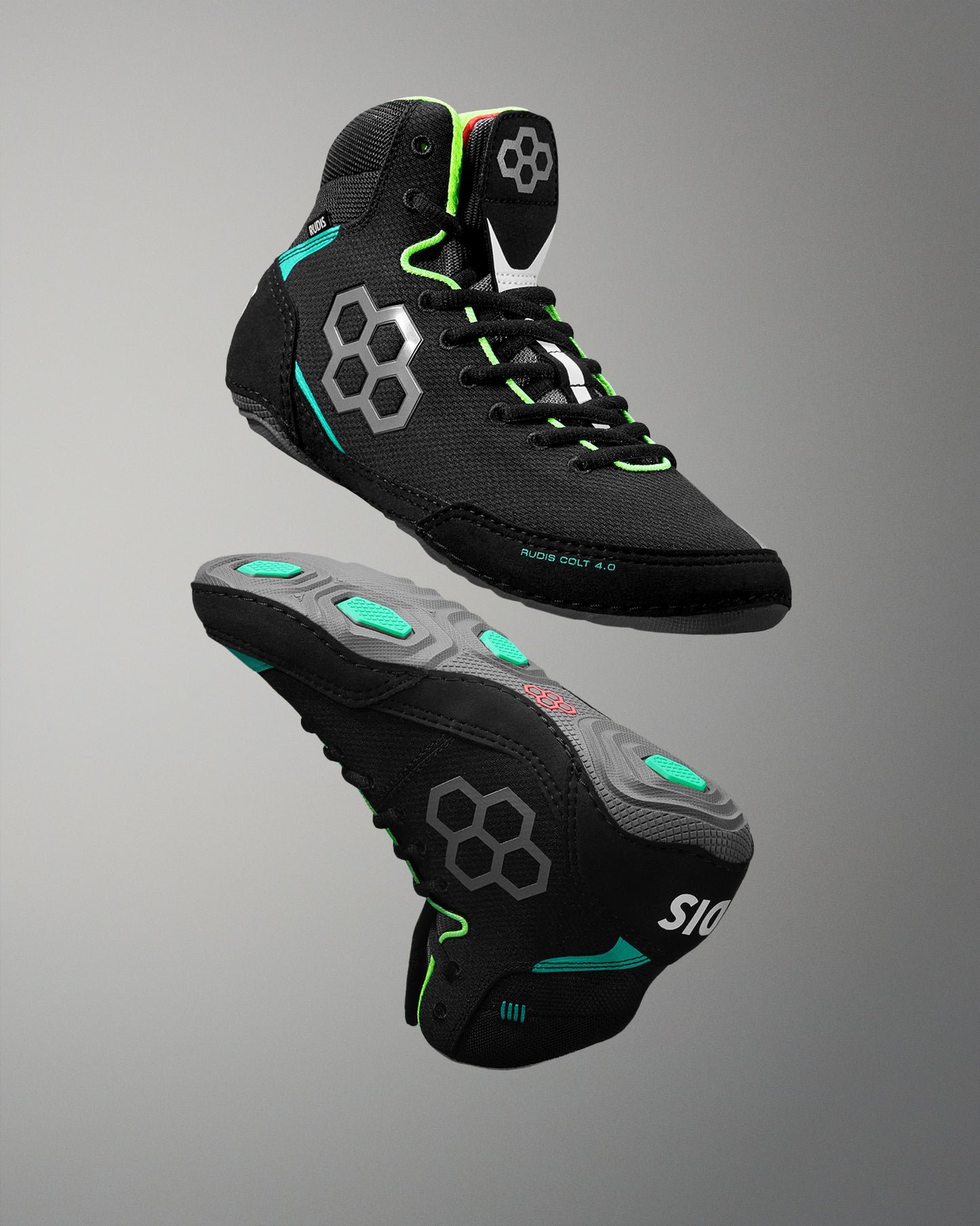 Black wrestling shoe with green accents on a gray background