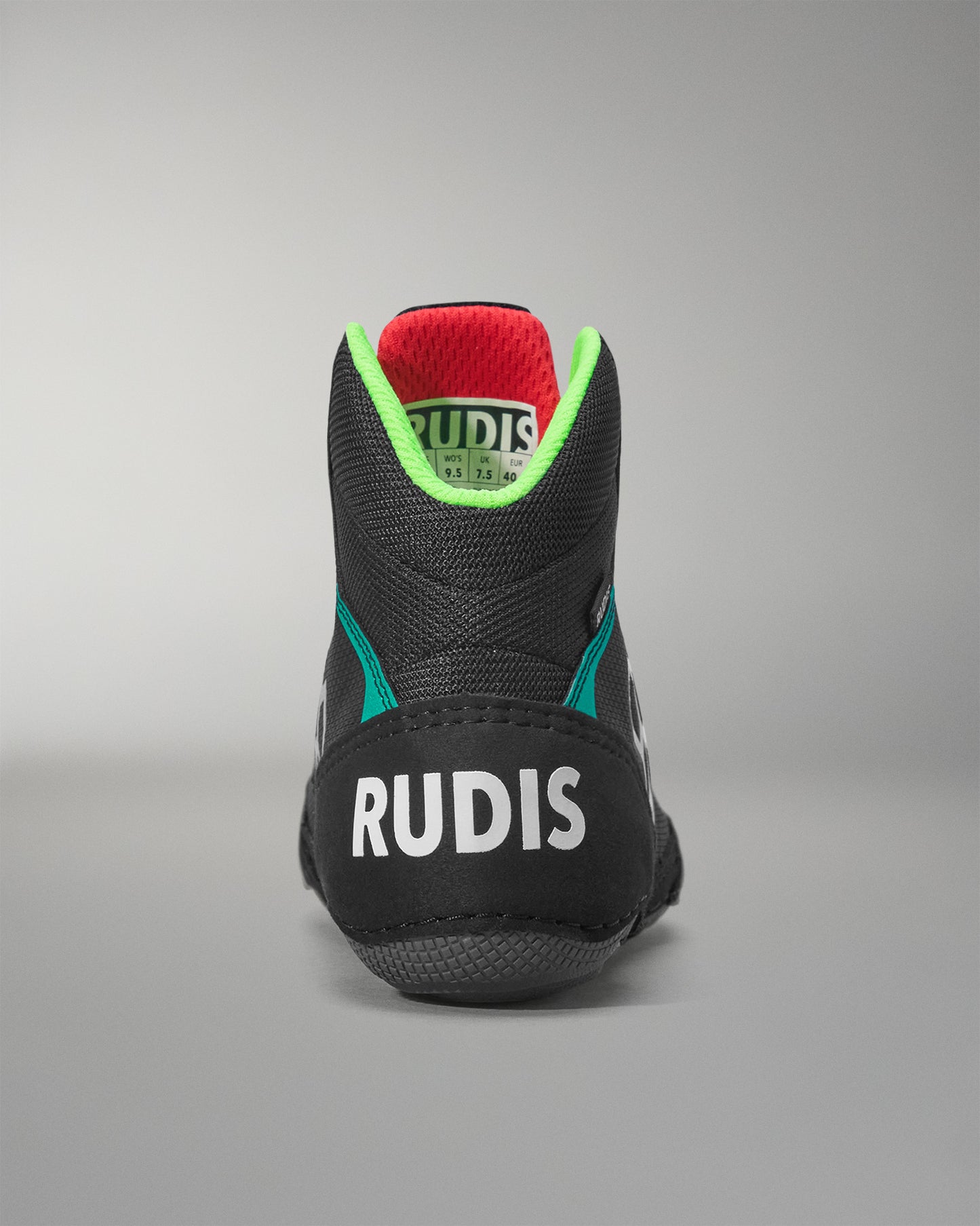 Black wrestling shoe with 'RUDIS' branding on a gray background
