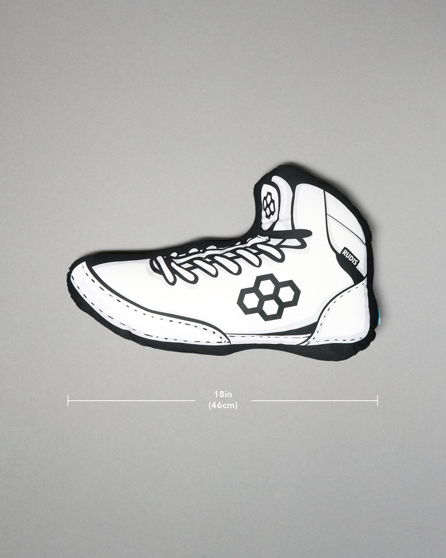 White wrestling shoe pillow with black accents on a gray background