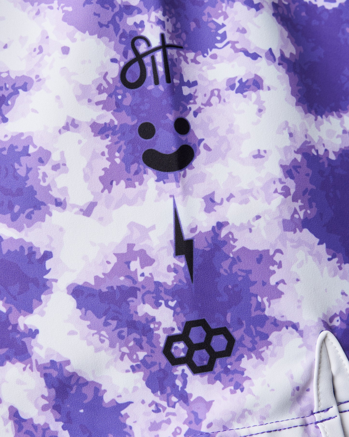 Purple tie-dye shorts with a brand logo on a gray background