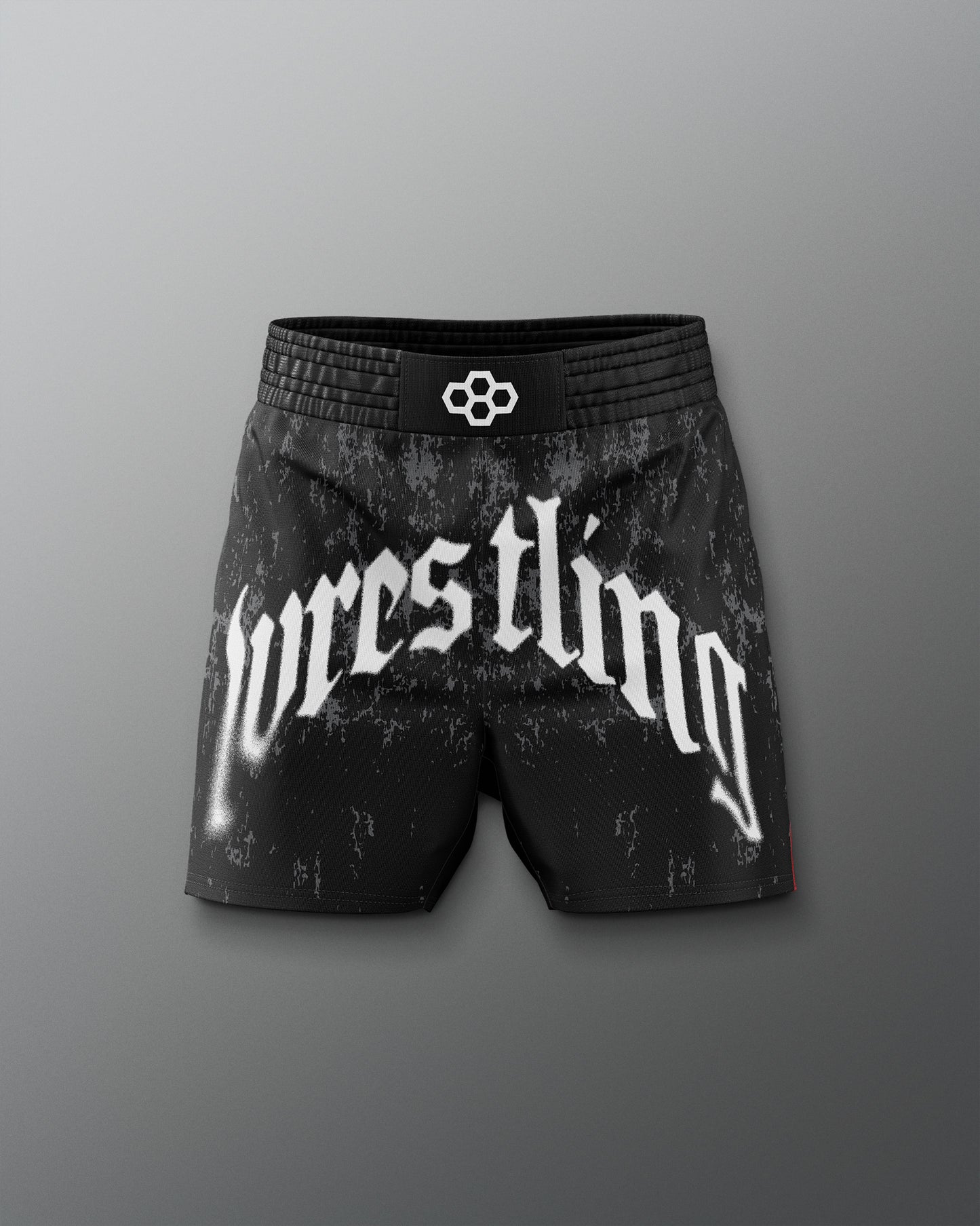 Black wrestling shorts with 'wrestling' text on a gray background