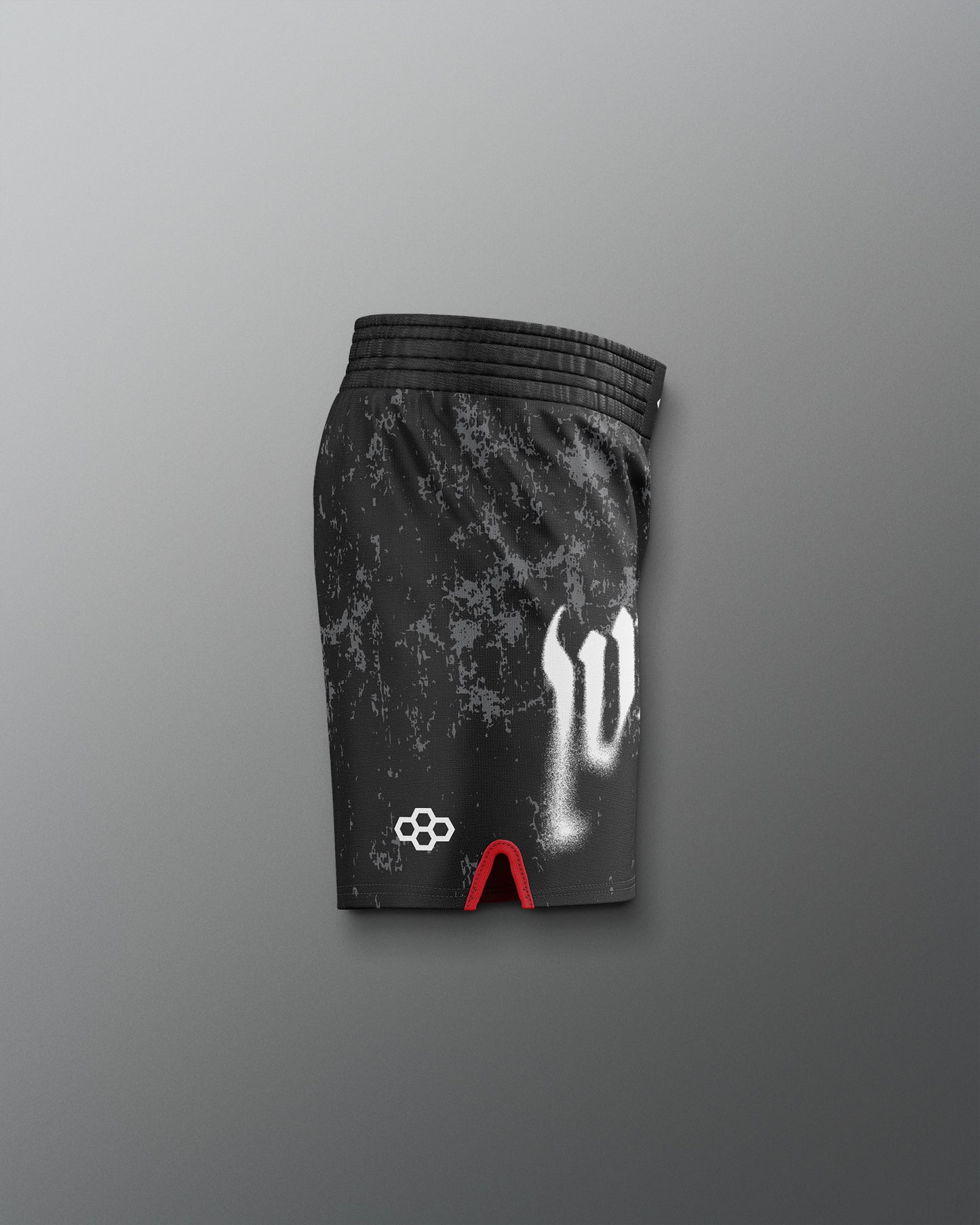 Black athletic shorts with white logo and red accents on a gray background