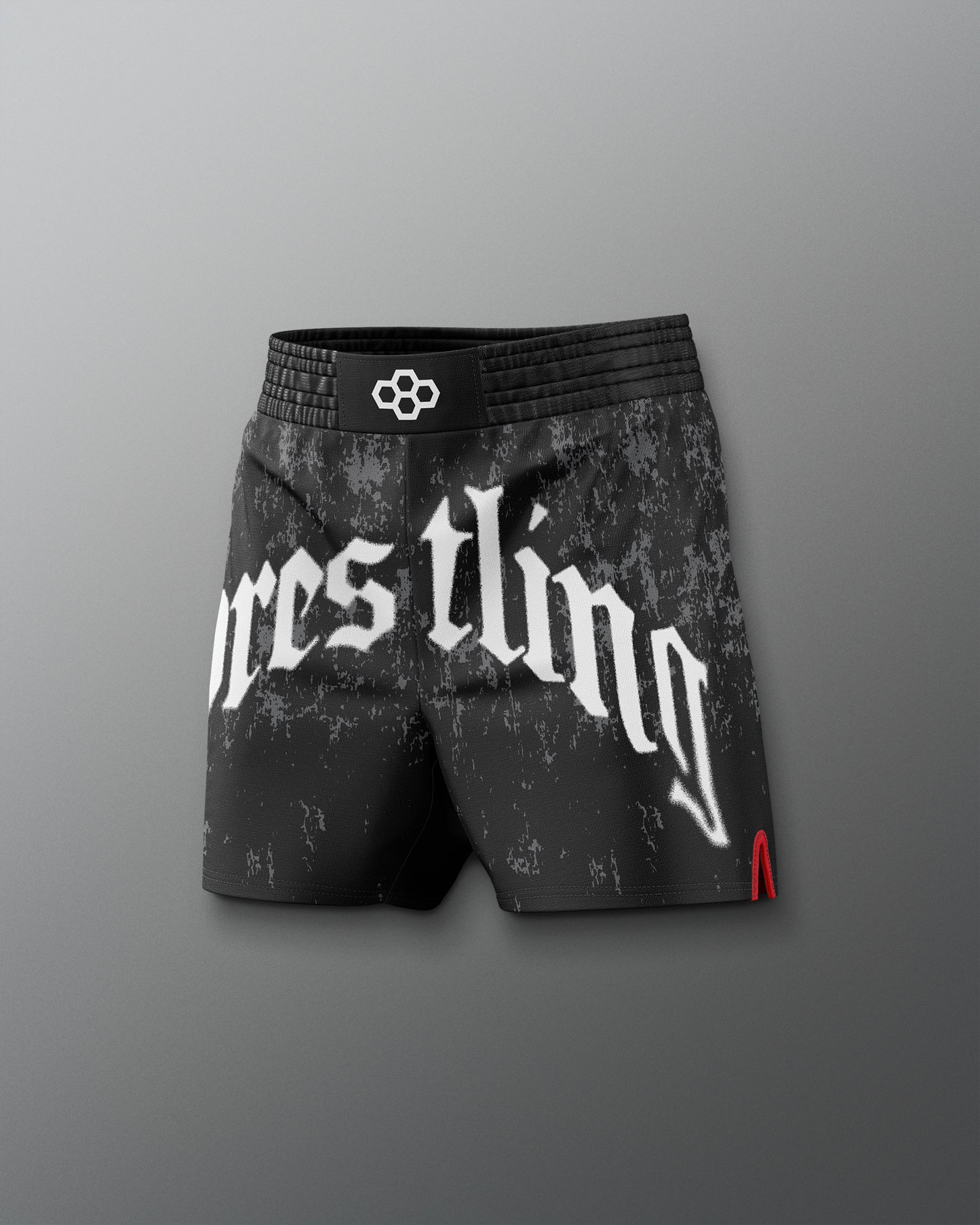 Black wrestling shorts with white text on a gray background