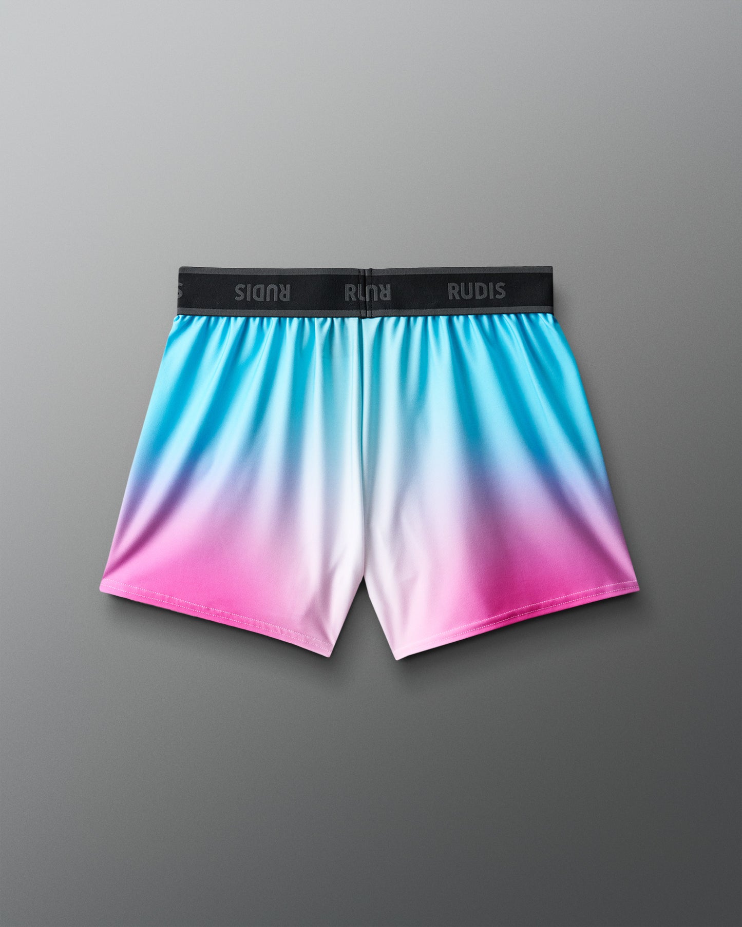 Gradient shorts with blue, pink, and white colors on a gray background