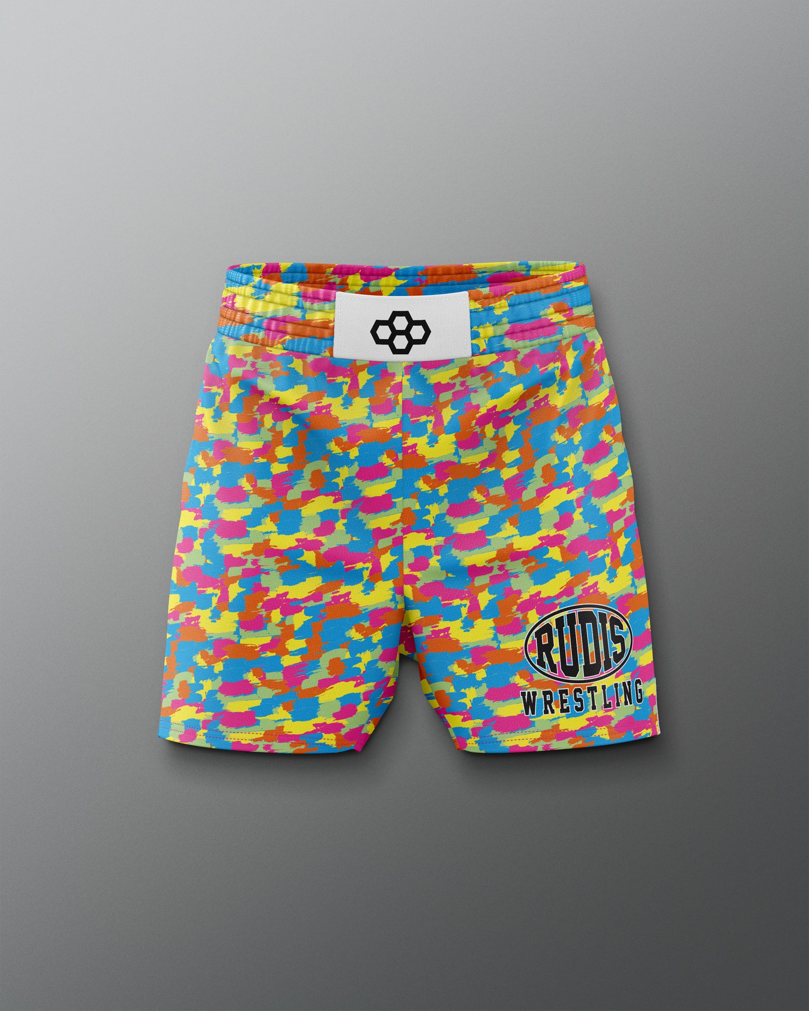Colorful camouflage wrestling shorts with a brand label on a gray background