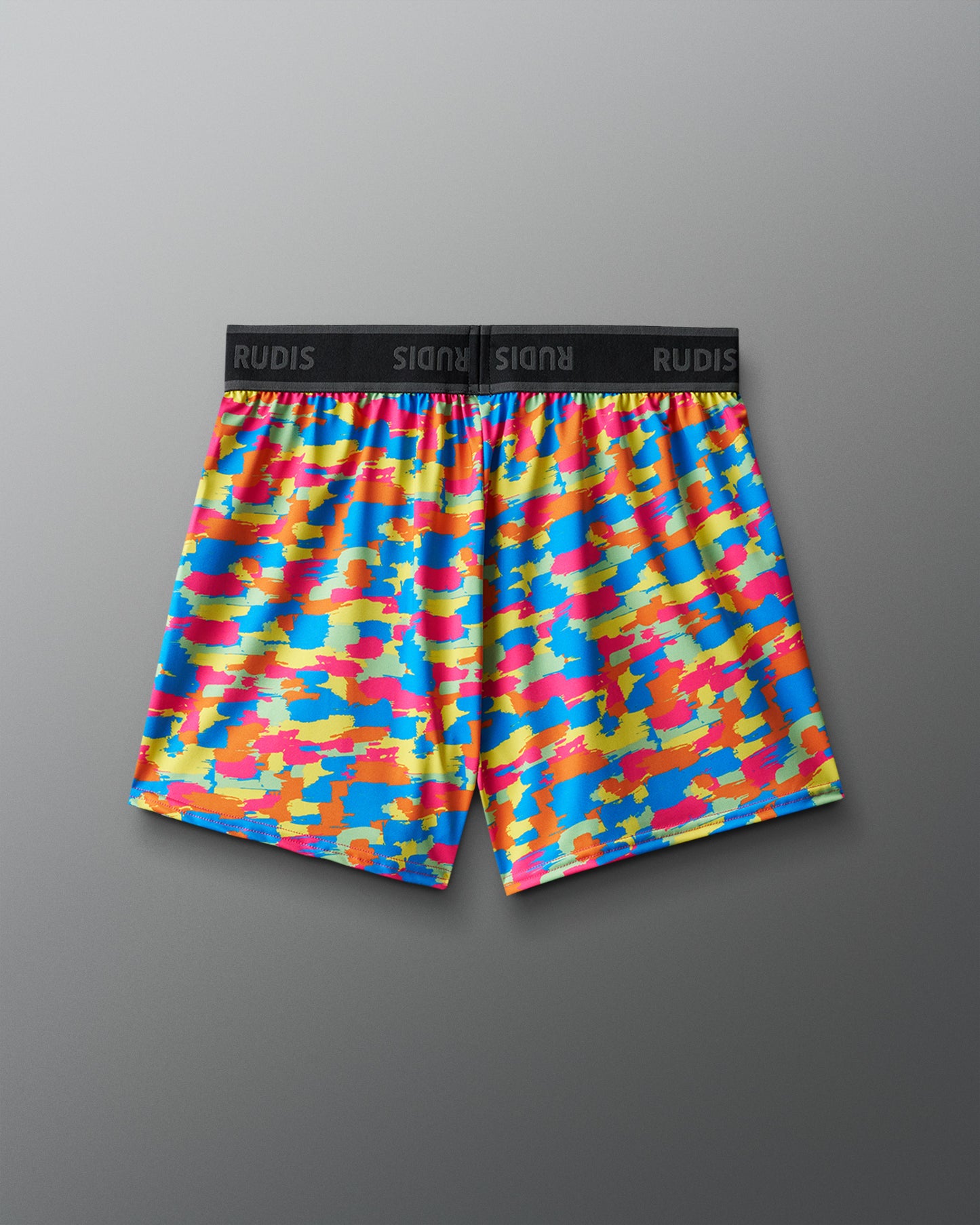 Colorful camouflage-patterned shorts on a gray background