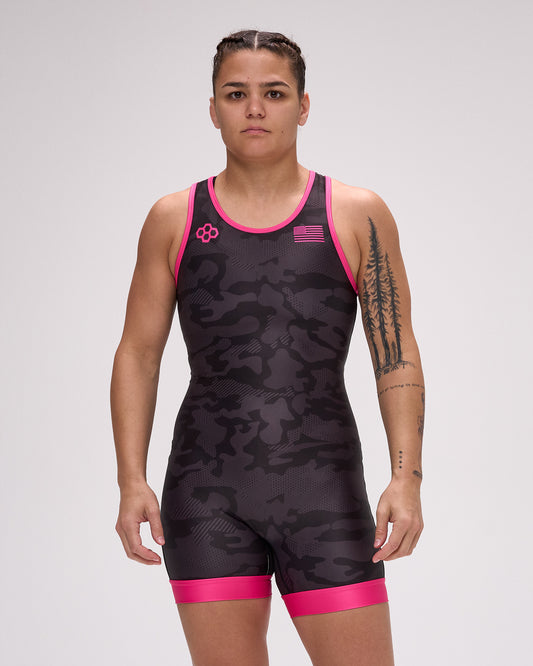 Person wearing a black and pink wrestling singlet with a logo on a white background