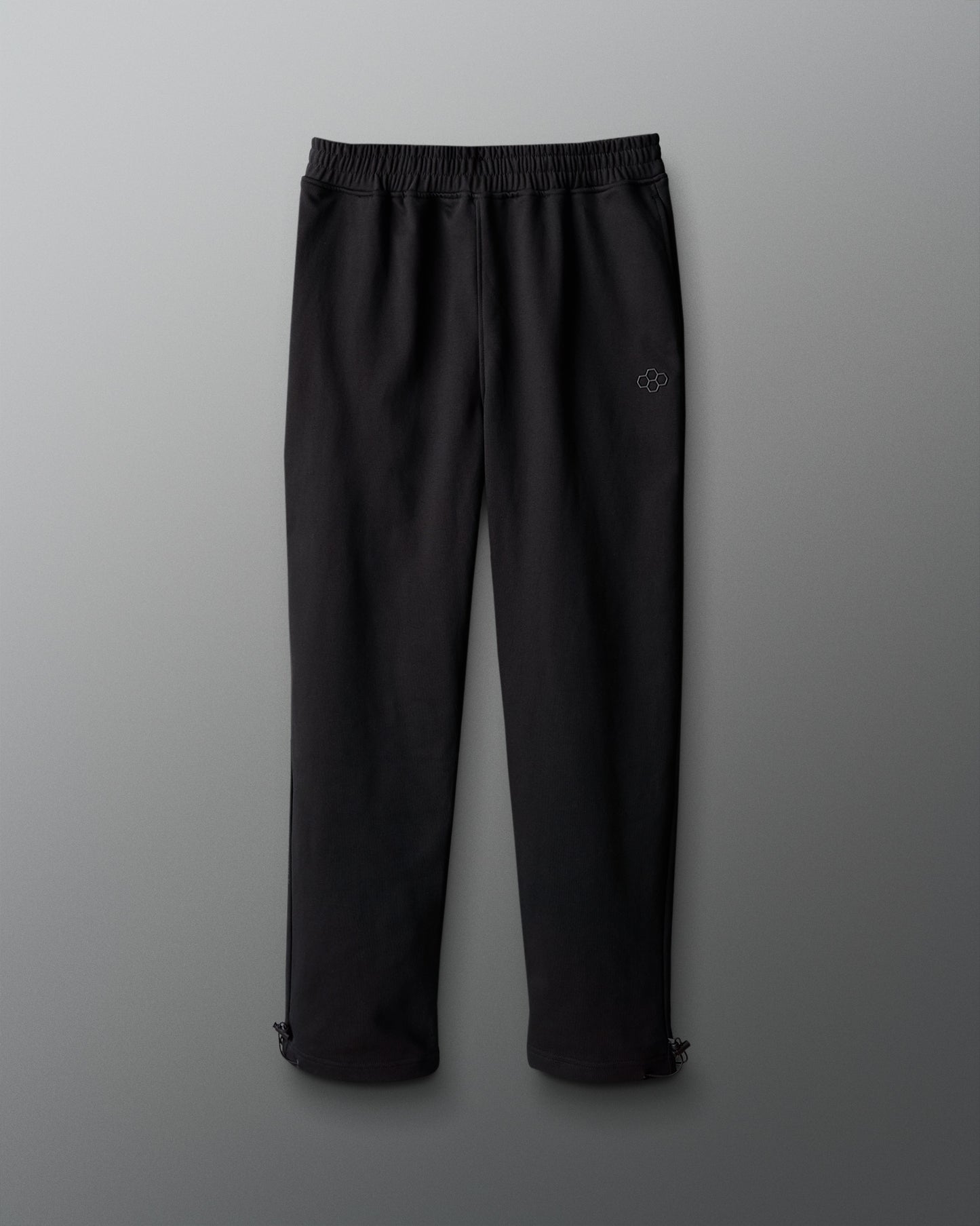 Black pants with a logo on a gray background