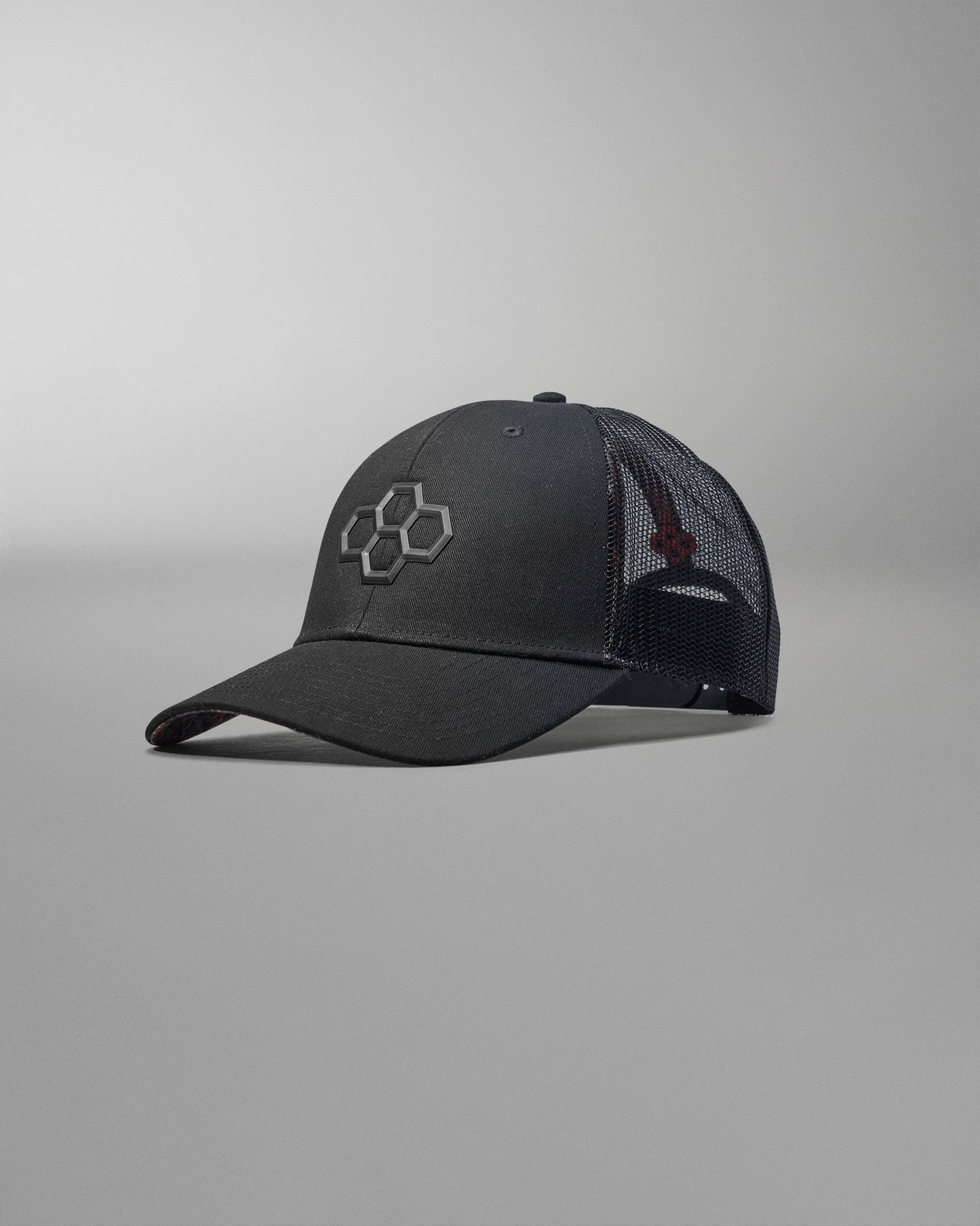Black baseball cap with a logo on a gray background