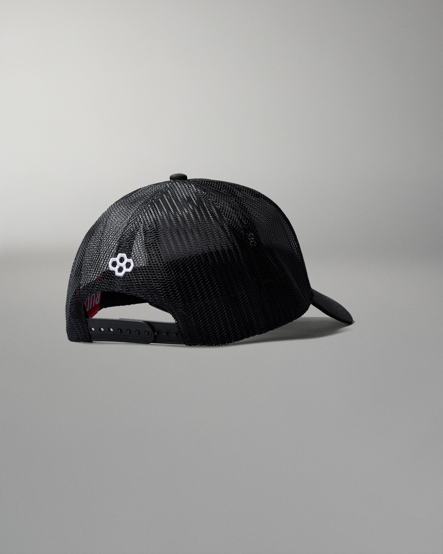 Black mesh cap with a logo on a gray background